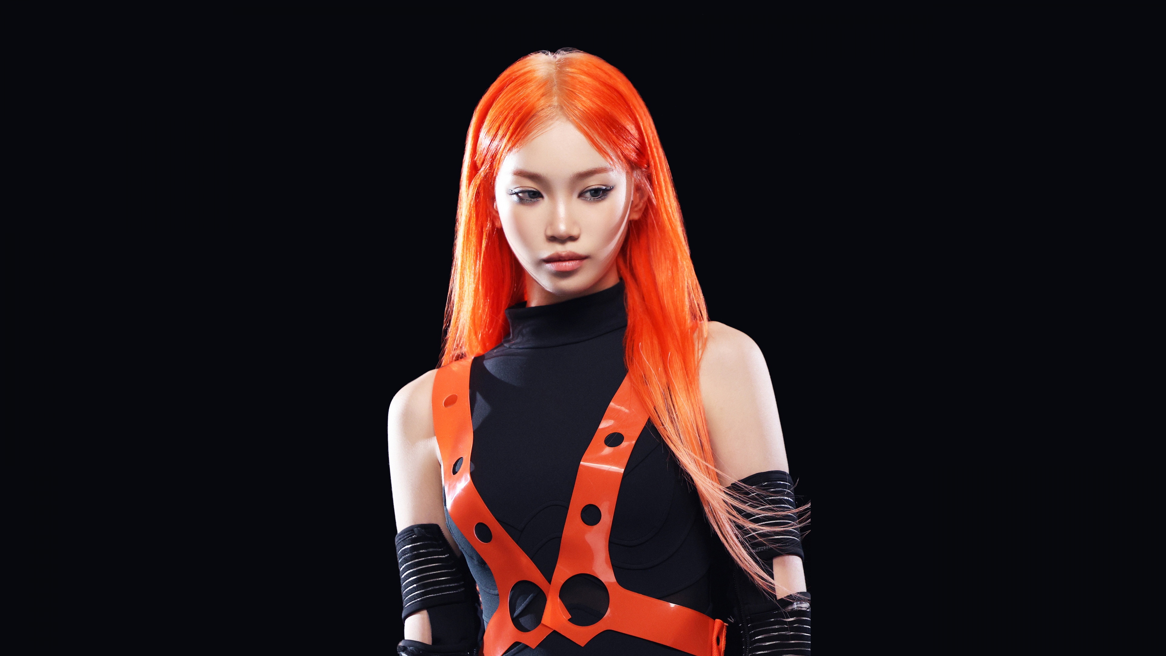 Kim Chaewon from LE SSERAFIM with vibrant orange hair against a black background