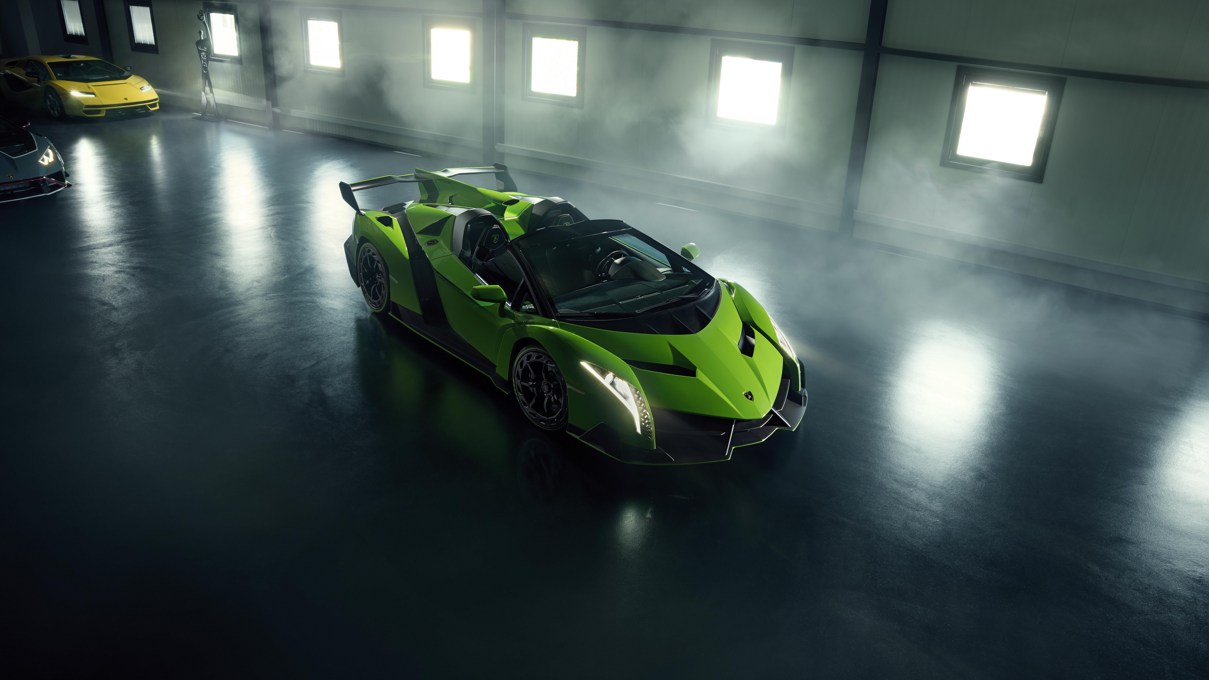 A vibrant green Lamborghini Veneno Roadster parked in a modern, high-end garage.