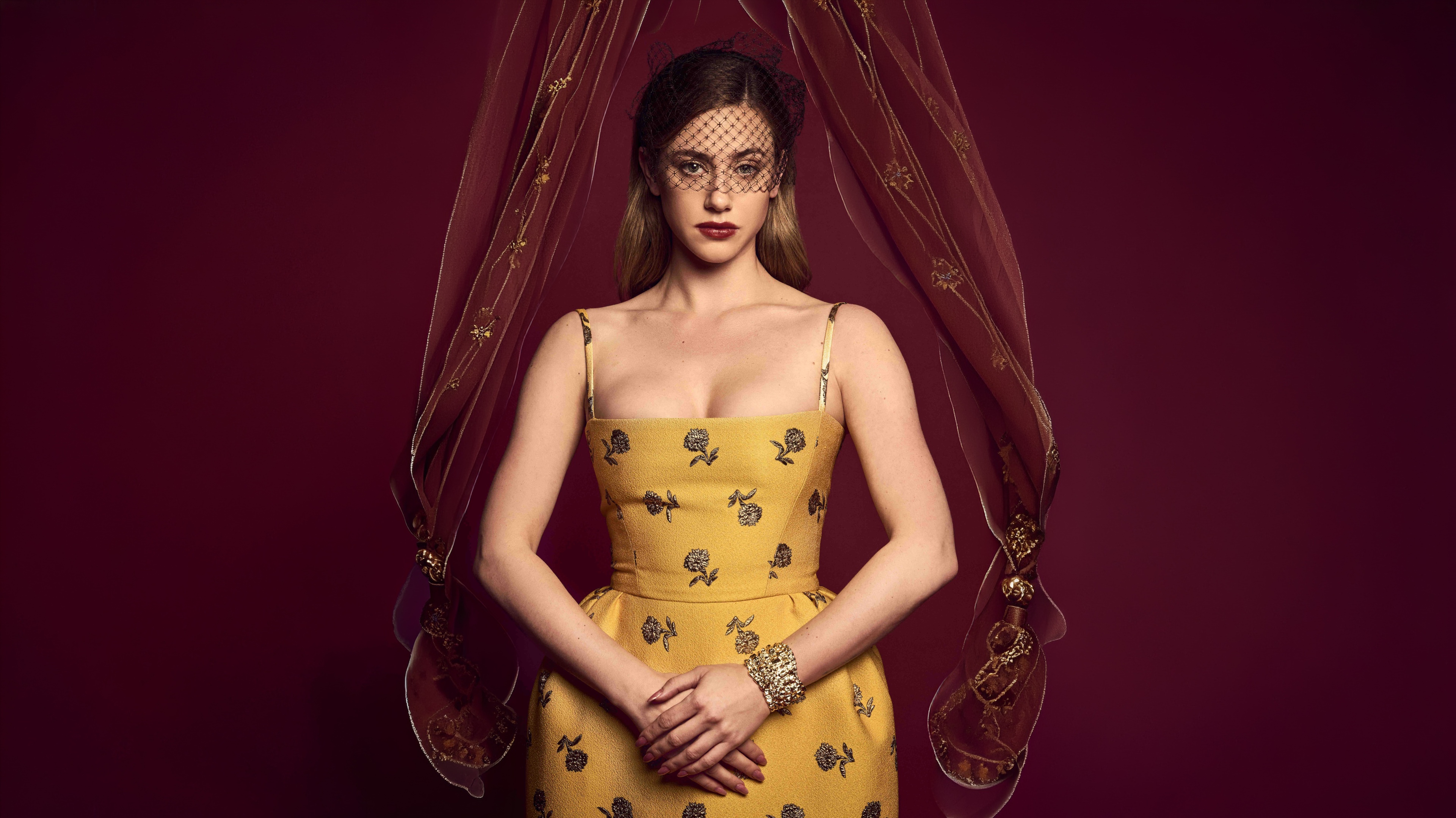 A high-resolution, cinematic portrait of Lili Reinhart against a vibrant red background, styled for a fashion magazine.