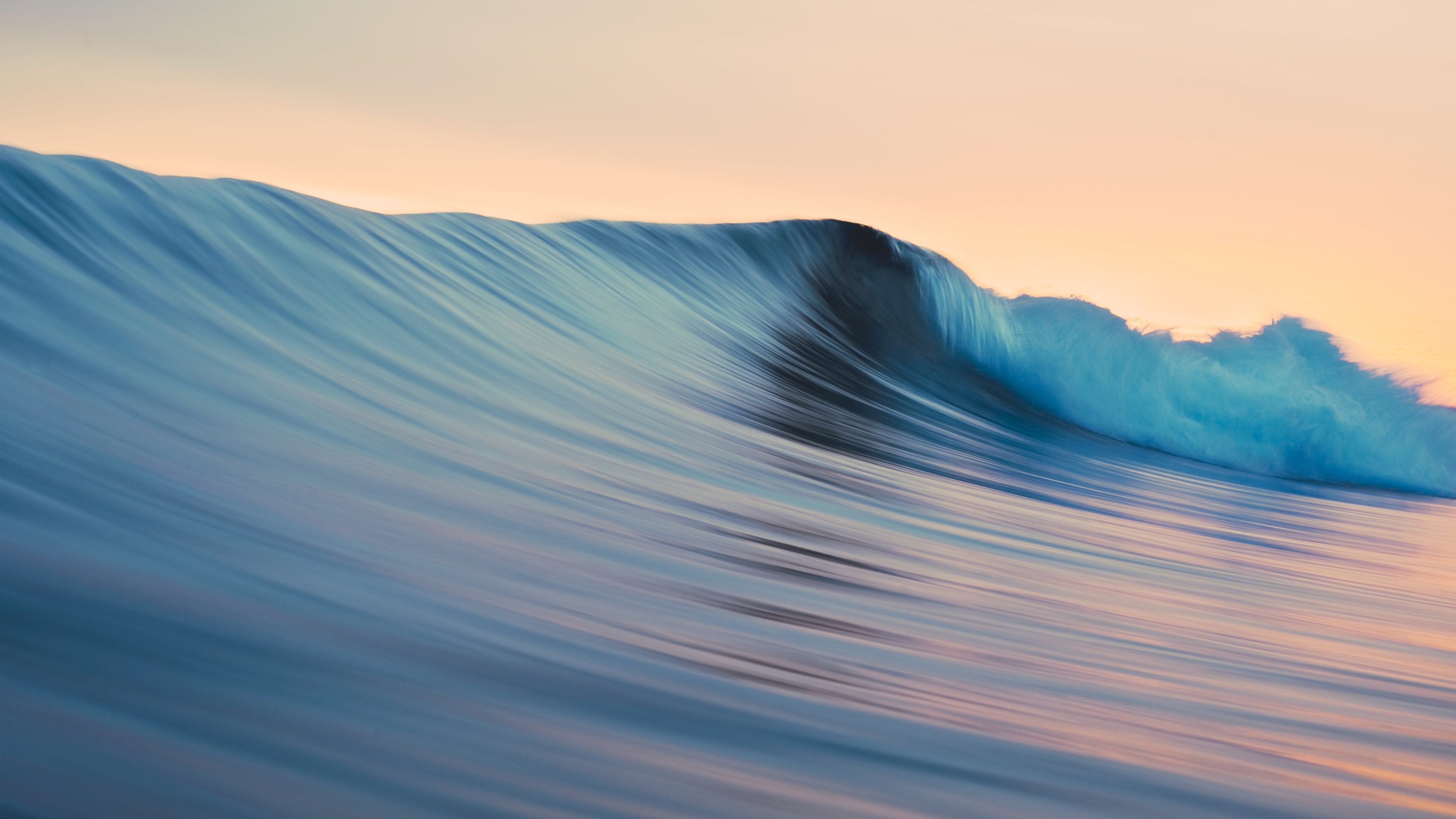 A high-resolution 5K seascape featuring deep blue ocean waves with white sea foam, inspired by the OS X Mavericks aesthetic.