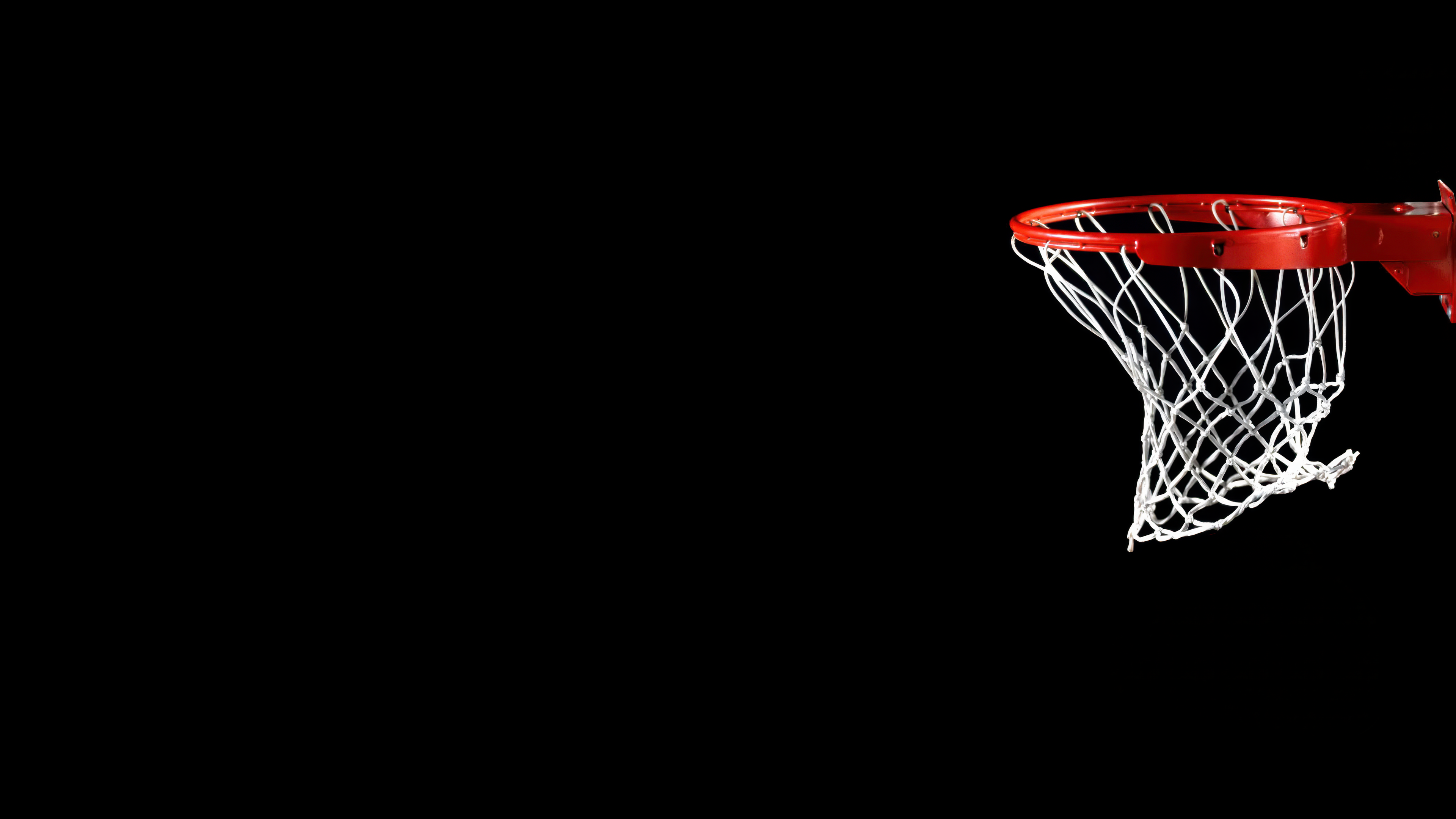 A minimalist basketball hoop centered against a solid black background with high-contrast lighting.