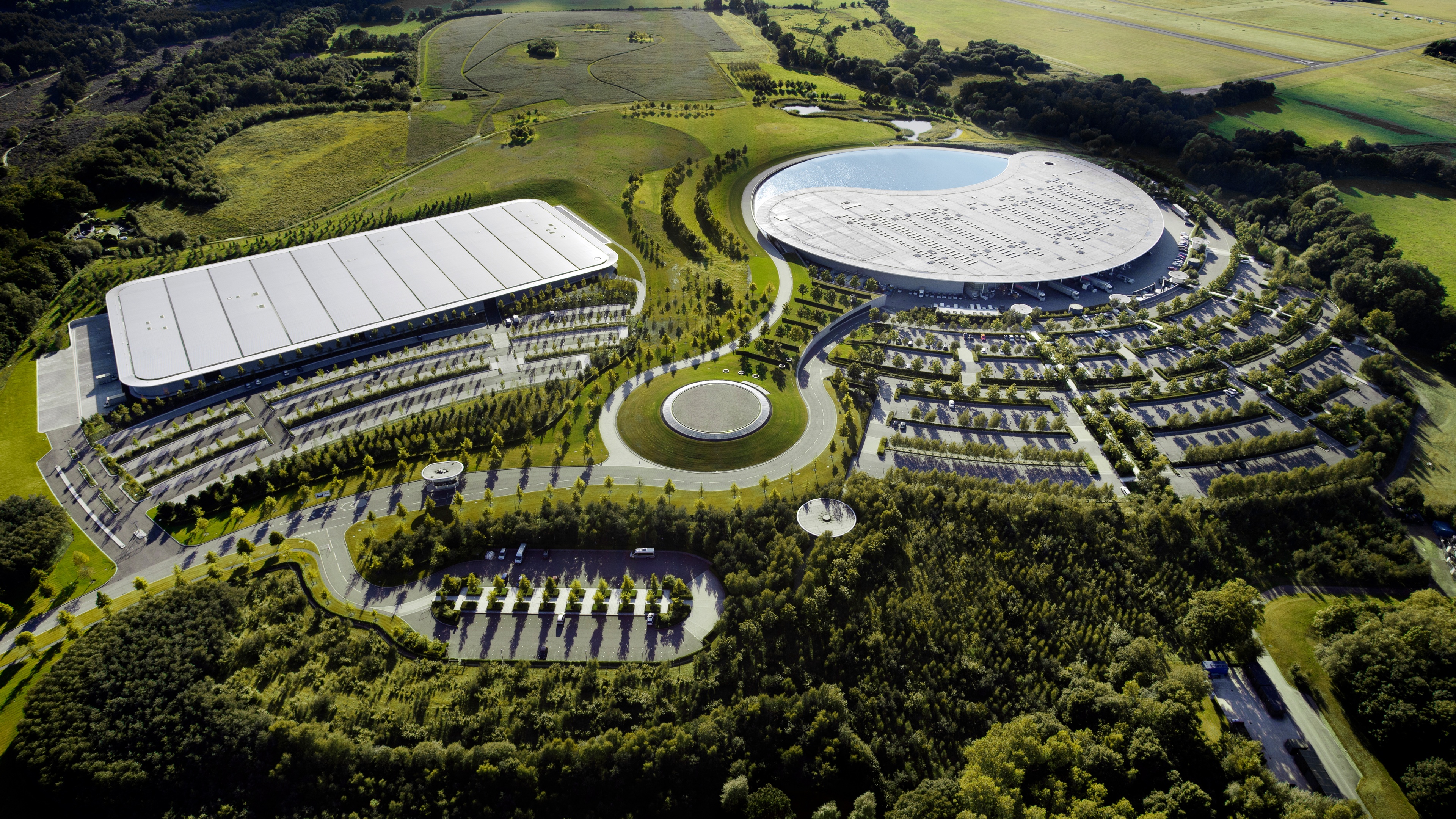 High-angle aerial view of a modern McLaren corporate office building featuring contemporary architecture in England.