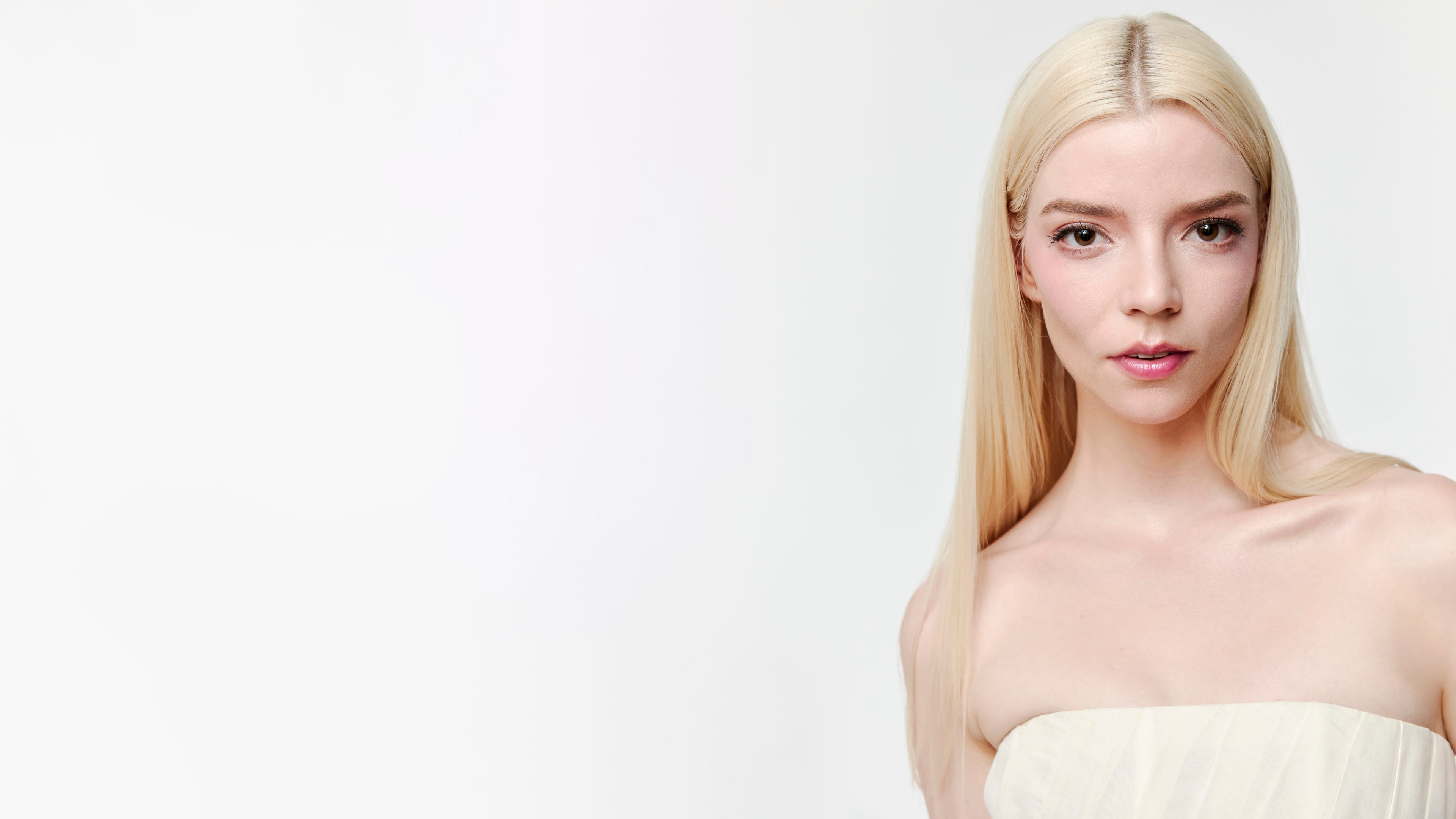 High-resolution 5K portrait of blonde actress Anya Taylor-Joy on a white background