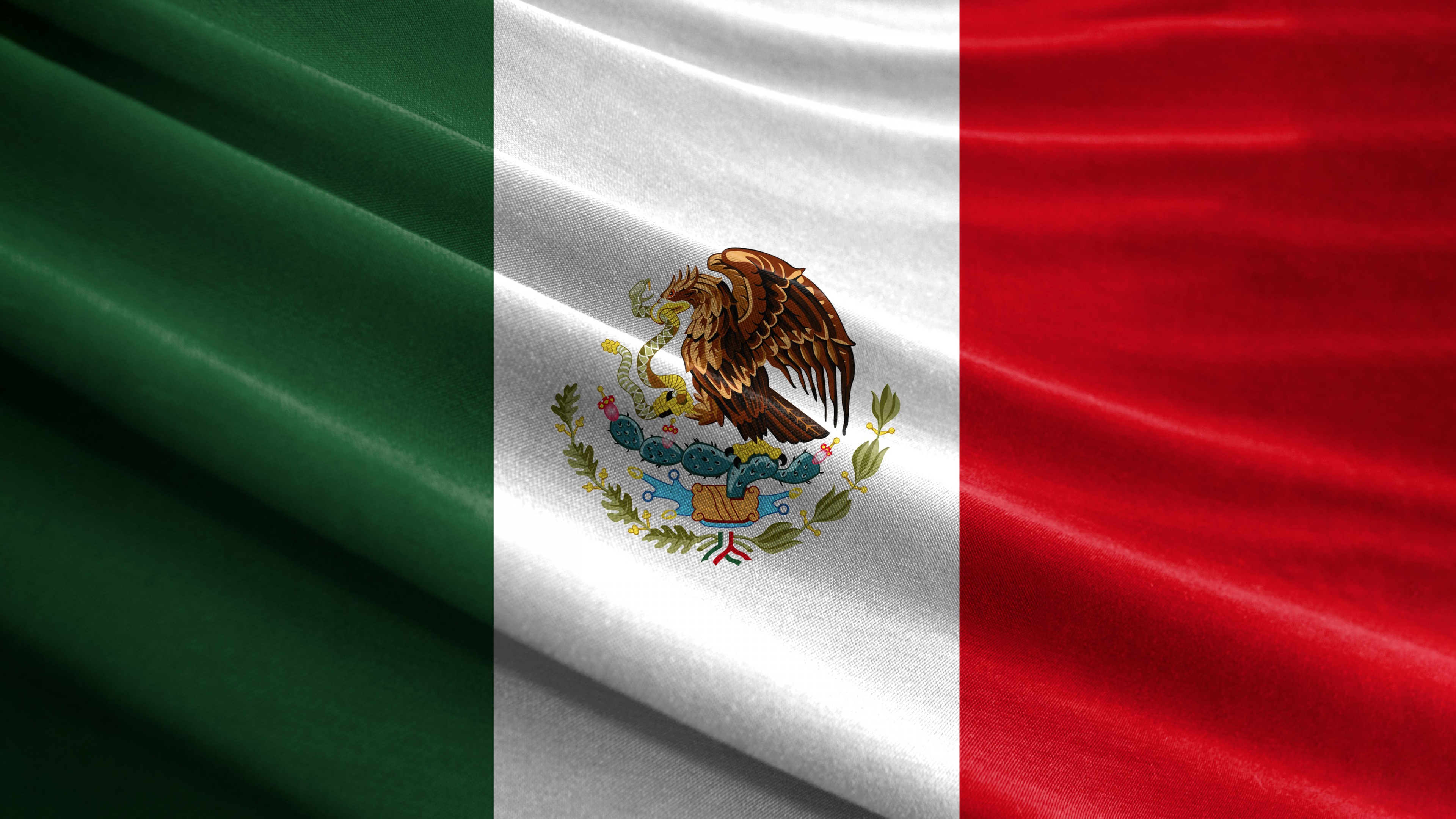 High-resolution close-up of the Mexican national flag featuring the eagle and serpent emblem.