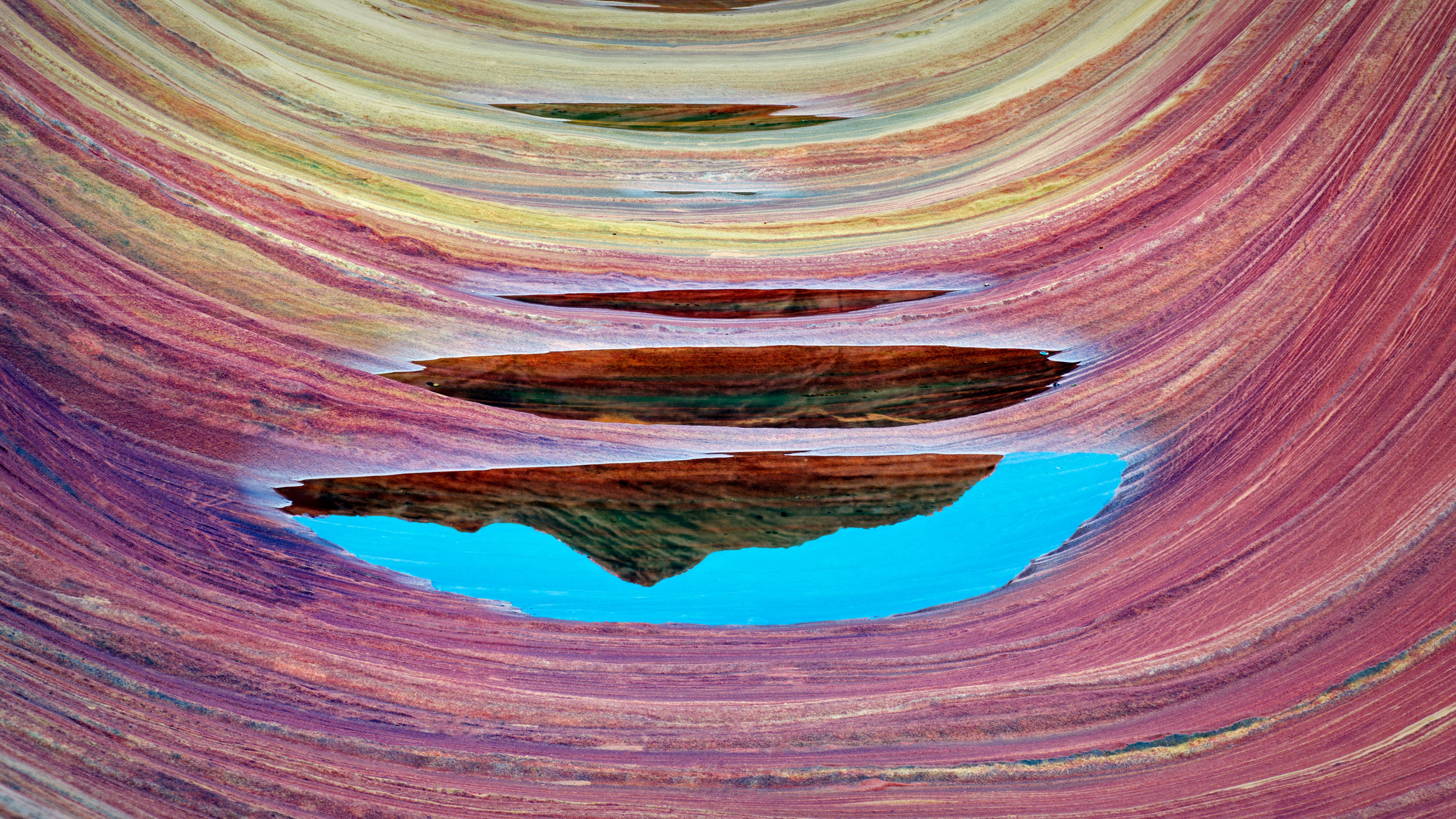 Intricate, colorful swirling sandstone rock formations of The Wave in Coyote Buttes, Arizona.