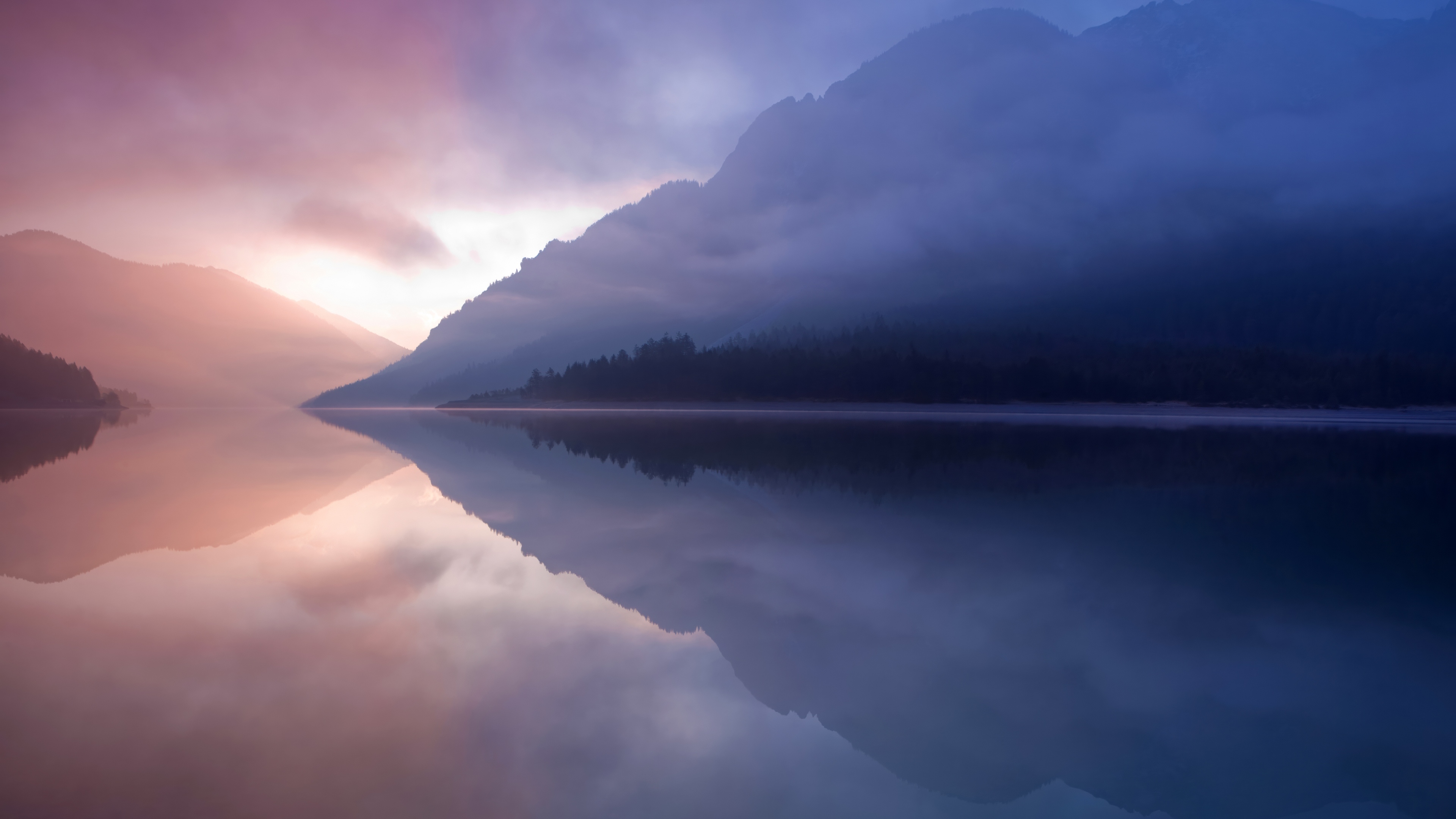 A peaceful landscape of a mountain lake with misty reflections, inspired by the Mac OS X Lion aesthetic.