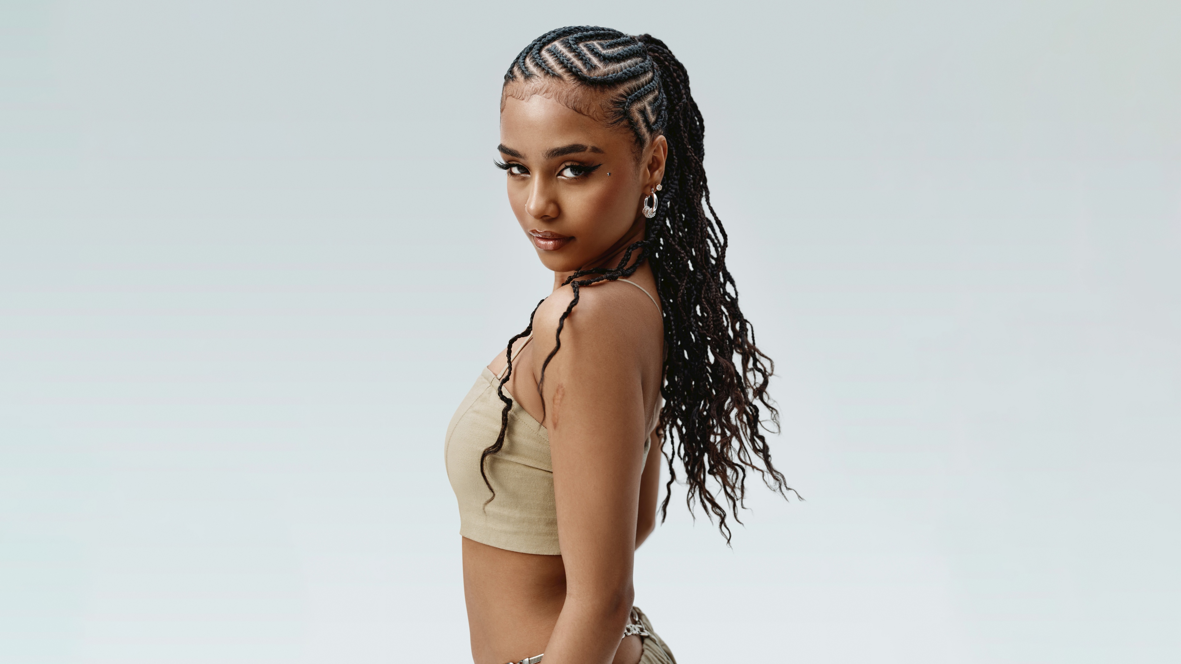 Close-up portrait of South African singer Tyla with detailed braided hair.