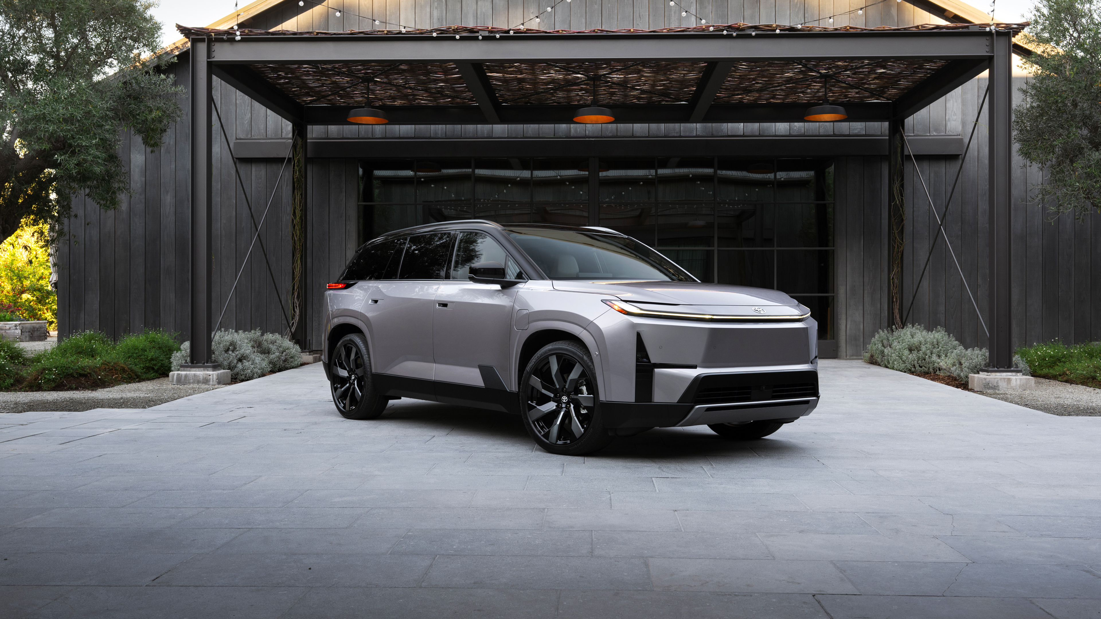 A futuristic, streamlined electric SUV with advanced LED lighting and a polished metallic finish, representing the next generation of automotive design in 2027.