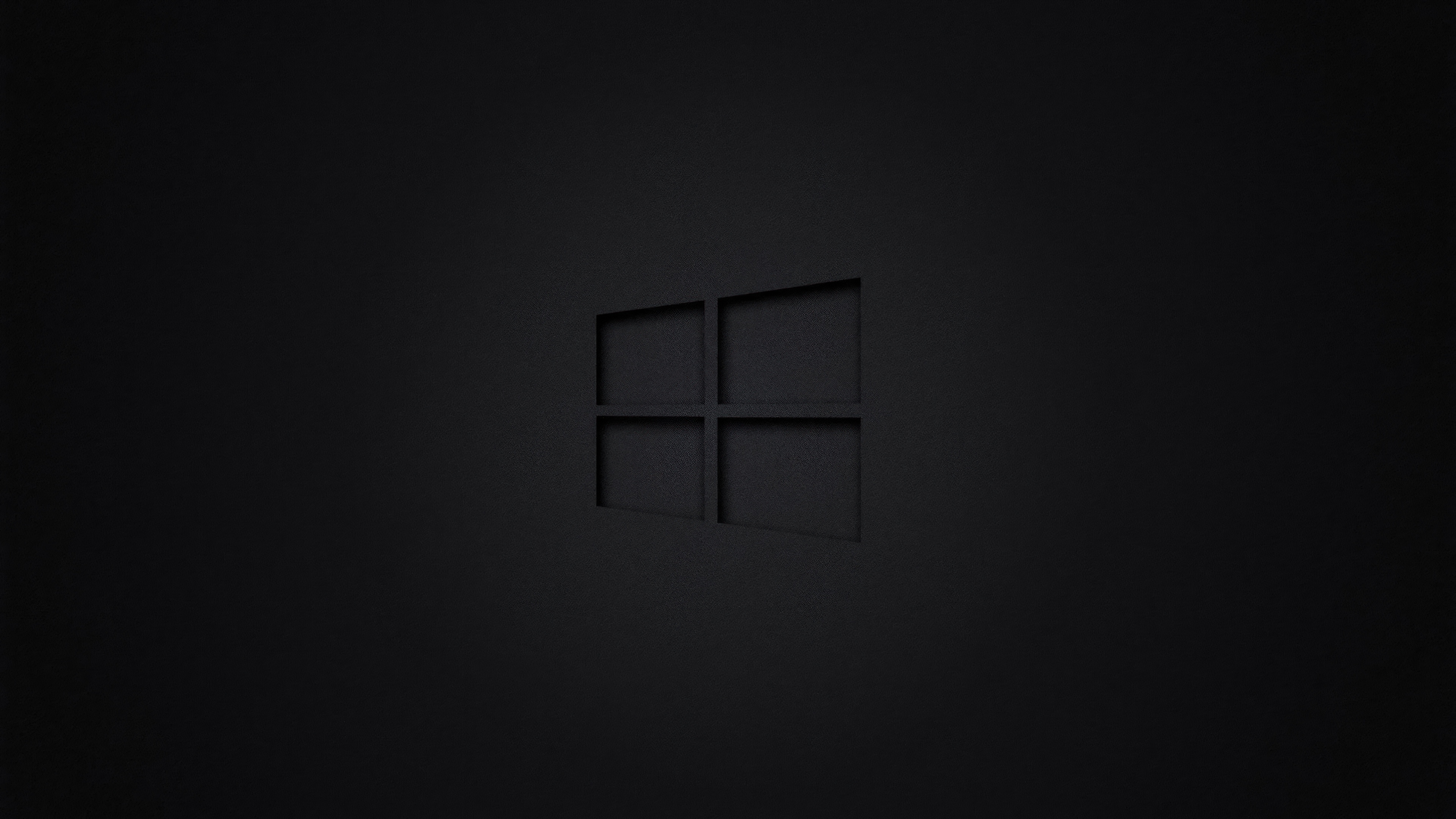 Windows 10 logo centered on a dark, minimalist background with a dark theme aesthetic.