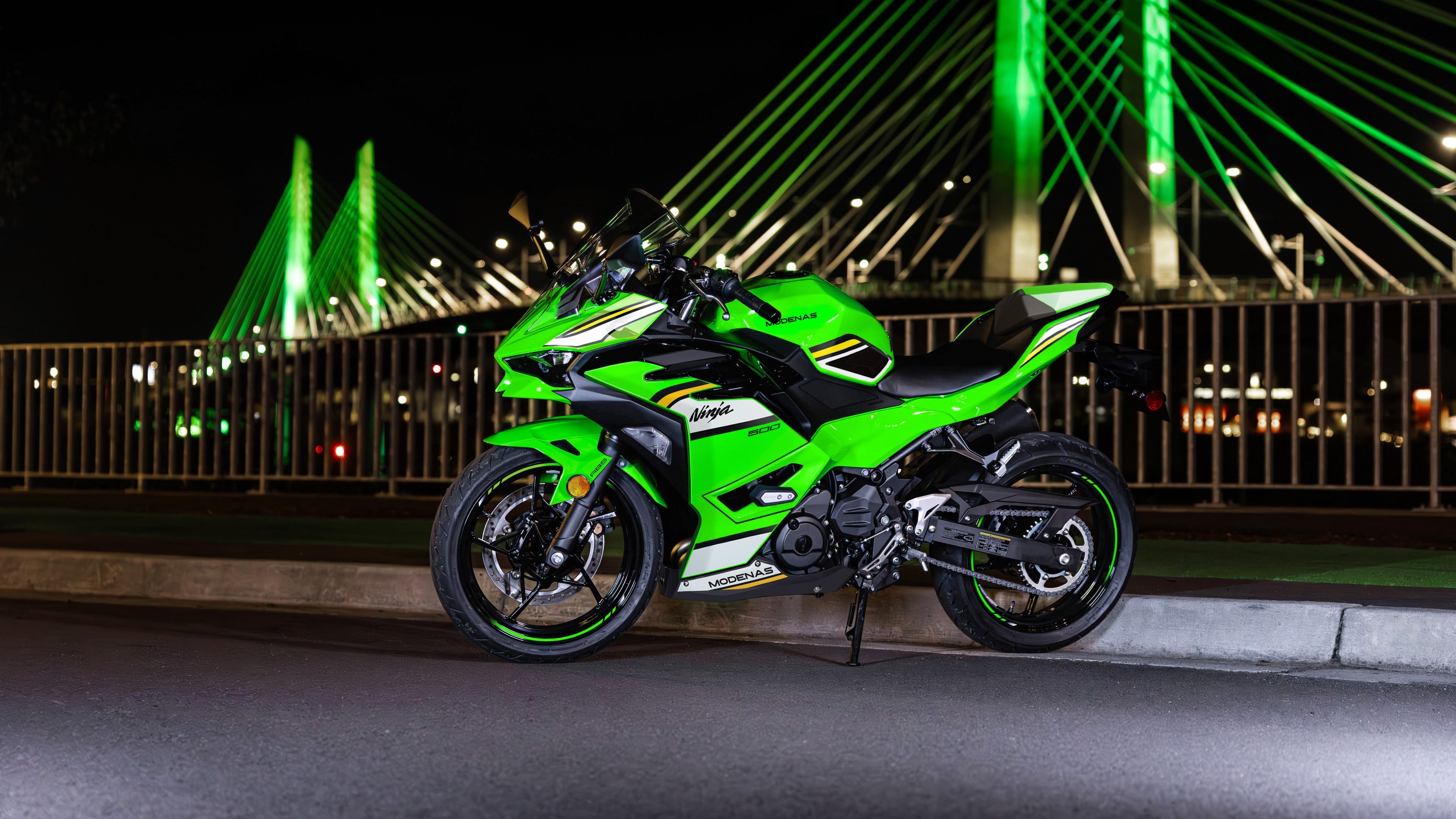 A high-resolution close-up of a 2025 Kawasaki Ninja 500 sports motorcycle featuring sharp aerodynamic lines and a sleek black and lime green design.