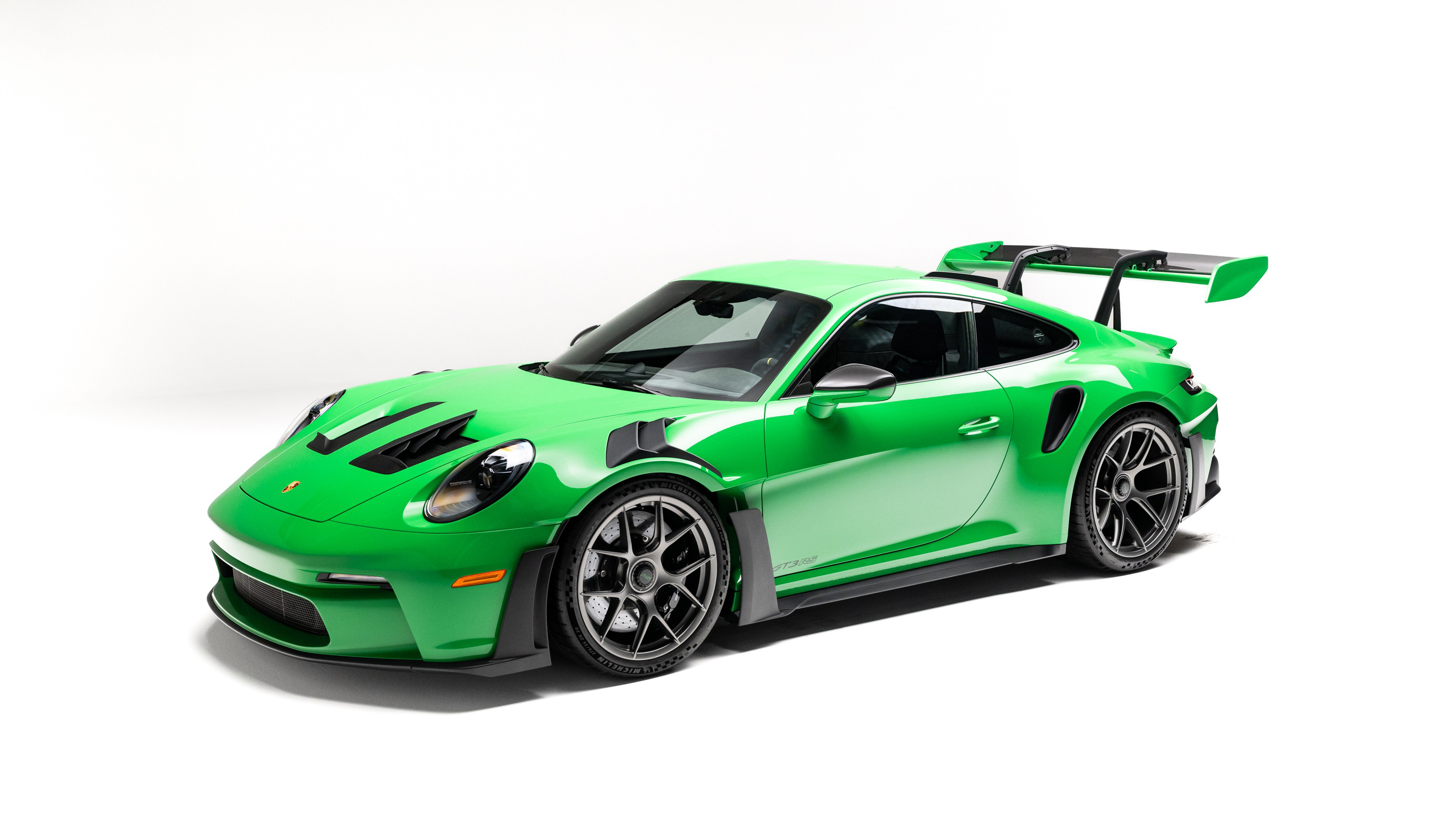 A 2025 Porsche 911 GT3 RS sports car isolated on a plain white background.