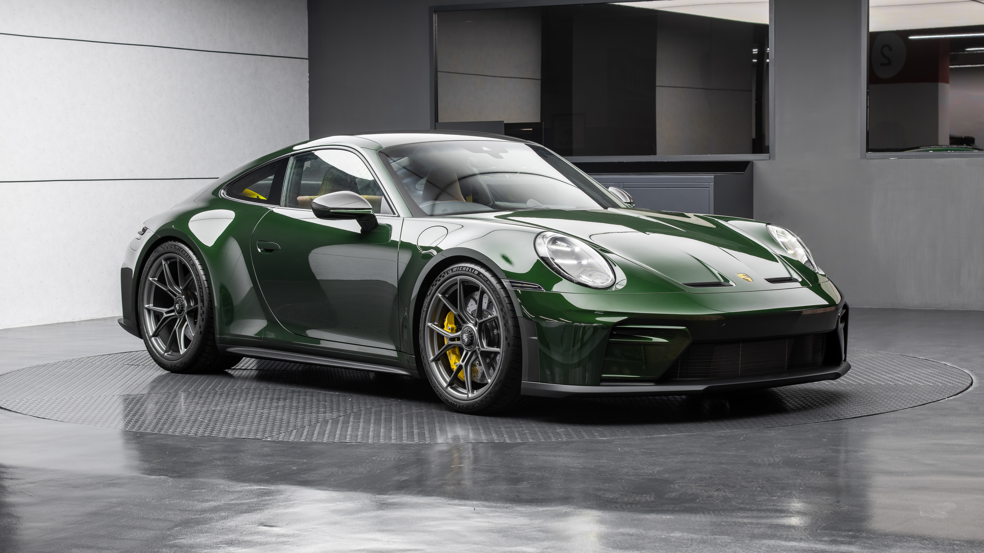 A detailed, high-resolution view of the 2025 Porsche 911 GT3 Touring, emphasizing its sleek bodywork and premium automotive design.