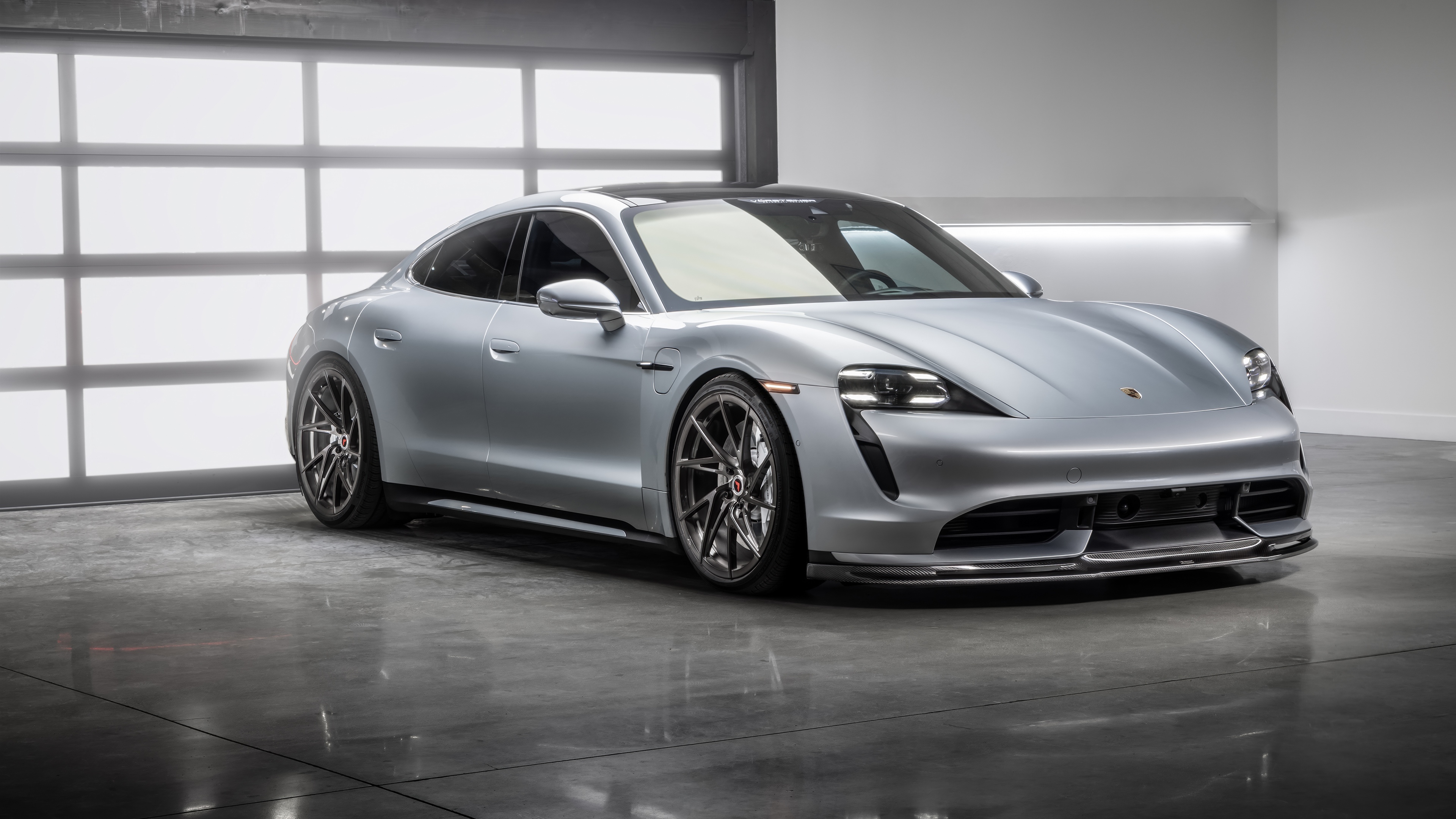 A high-performance Porsche Taycan featuring custom Vorsteiner wheels and aerodynamic styling.