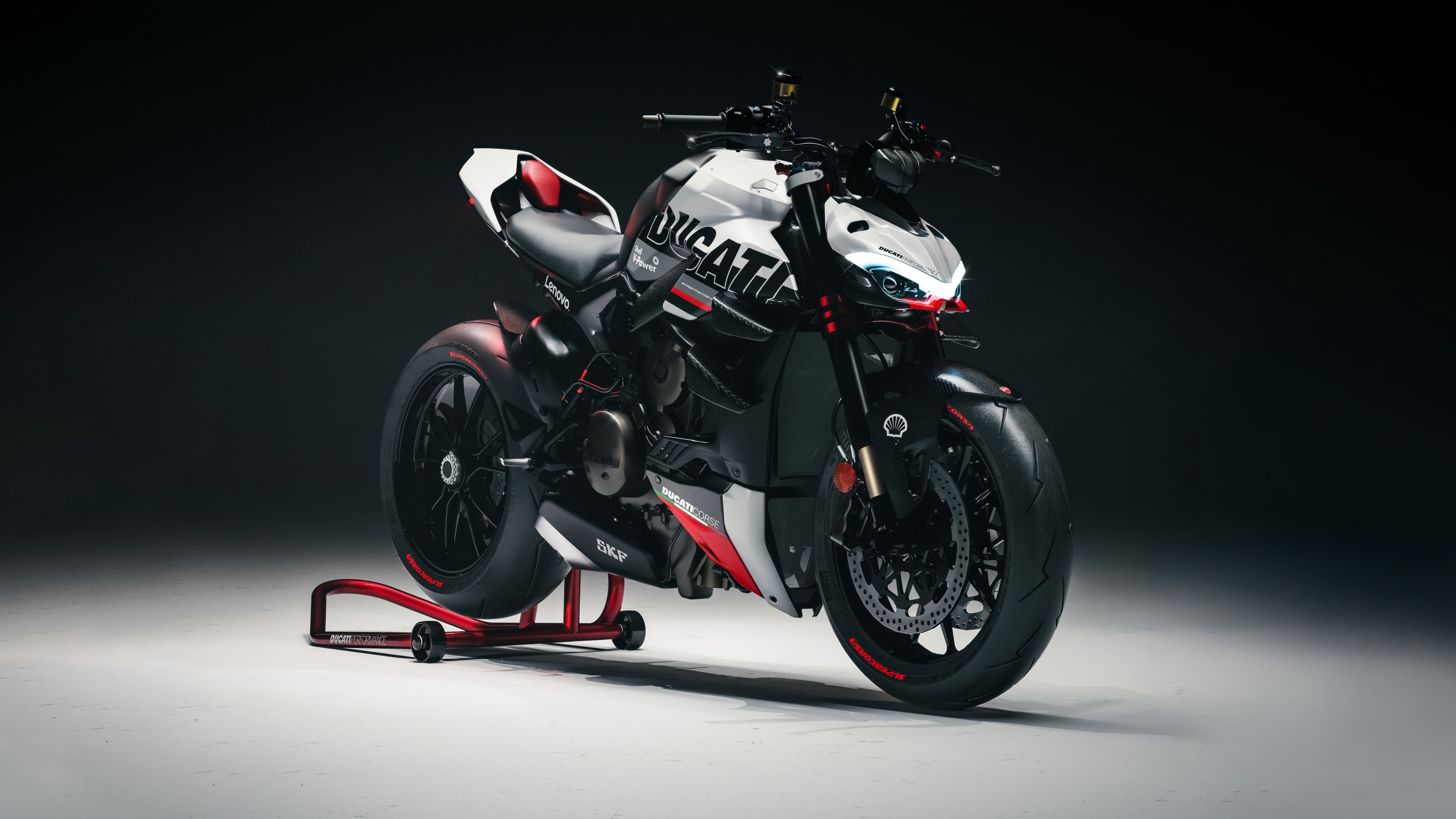 A high-detail, cinematic shot of a Ducati Streetfighter V4 motorcycle featuring a dark, moody background and sharp lighting.