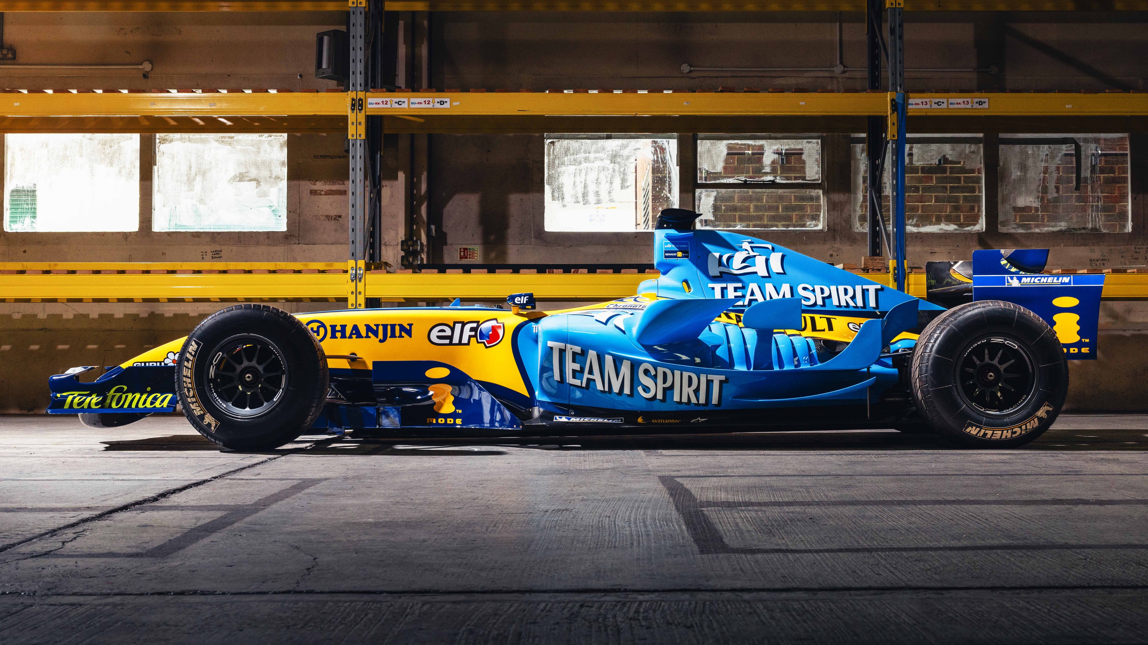 A high-resolution close-up of a modern Formula One racing car speeding through a corner.
