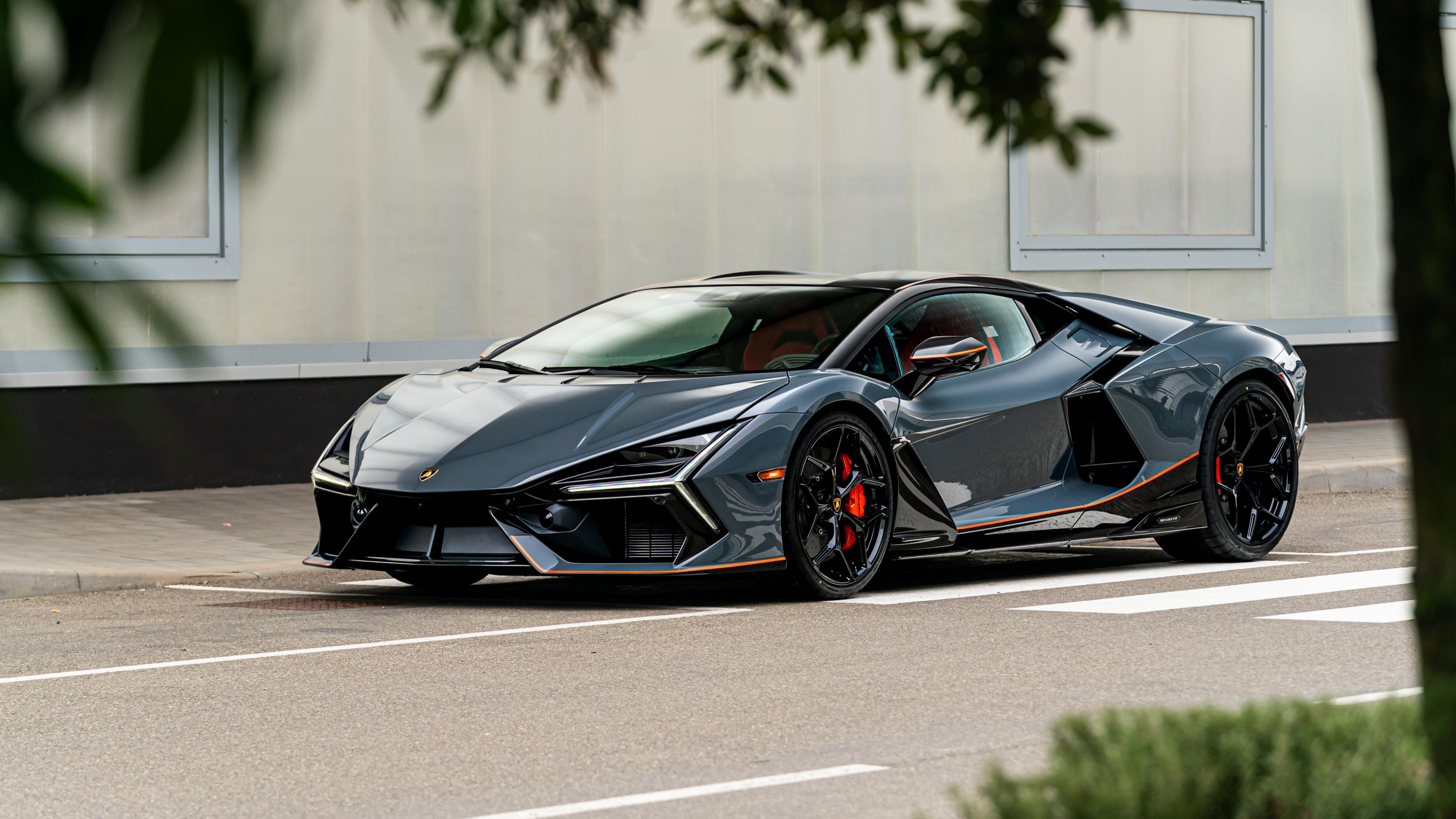 High-resolution close-up of a Lamborghini Revuelto hybrid sports car parked outdoors.