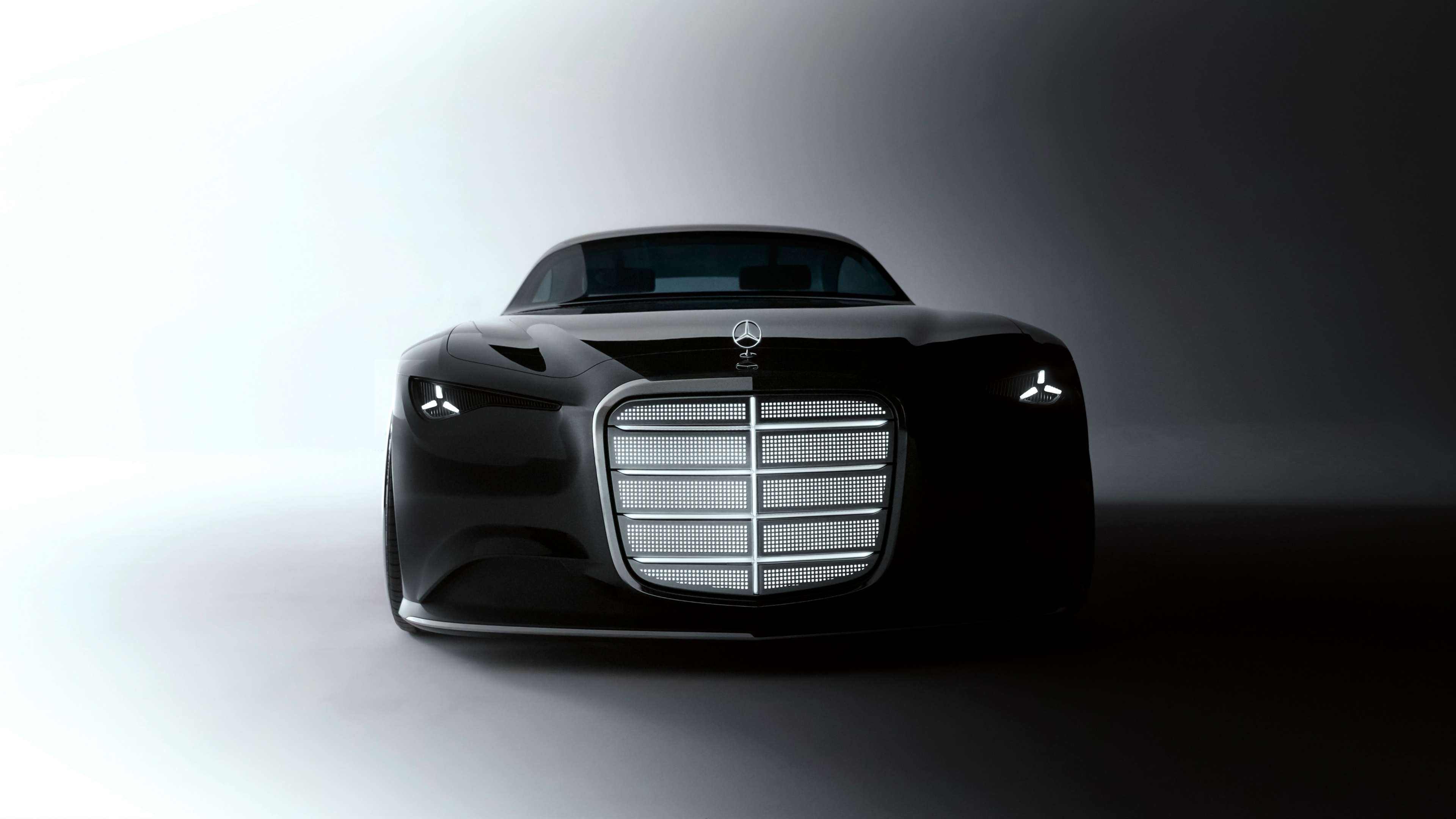 A sleek and futuristic black Mercedes-Benz Vision Iconic 2025 concept car.