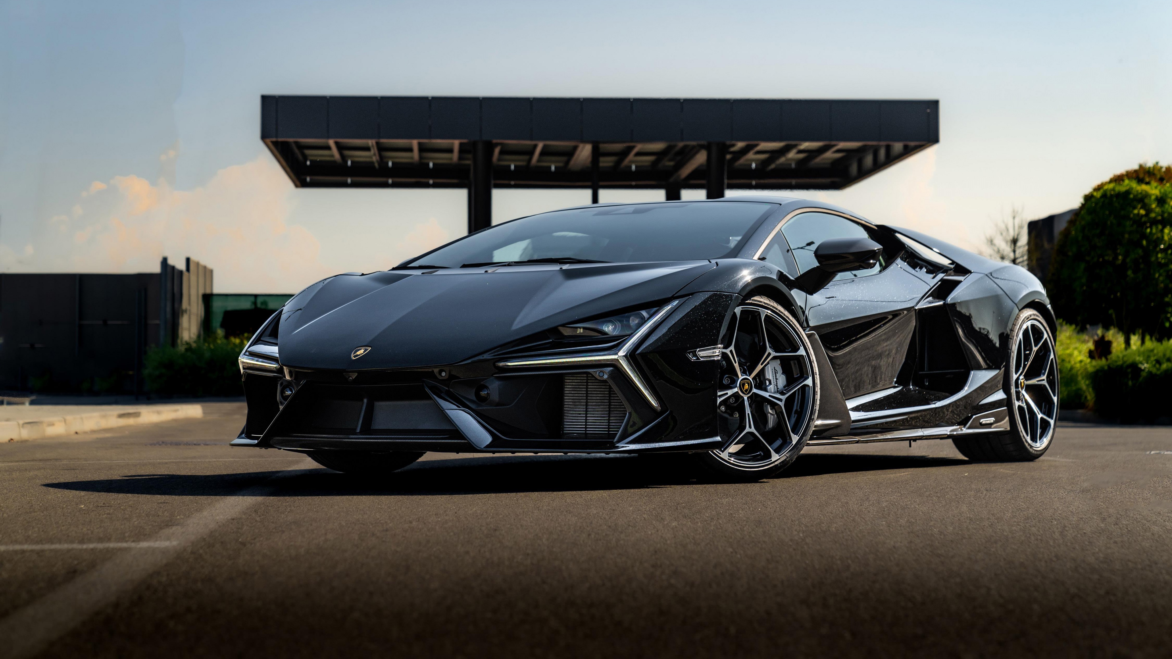 A high-resolution, detailed shot of a glossy black Lamborghini Revuelto supercar.