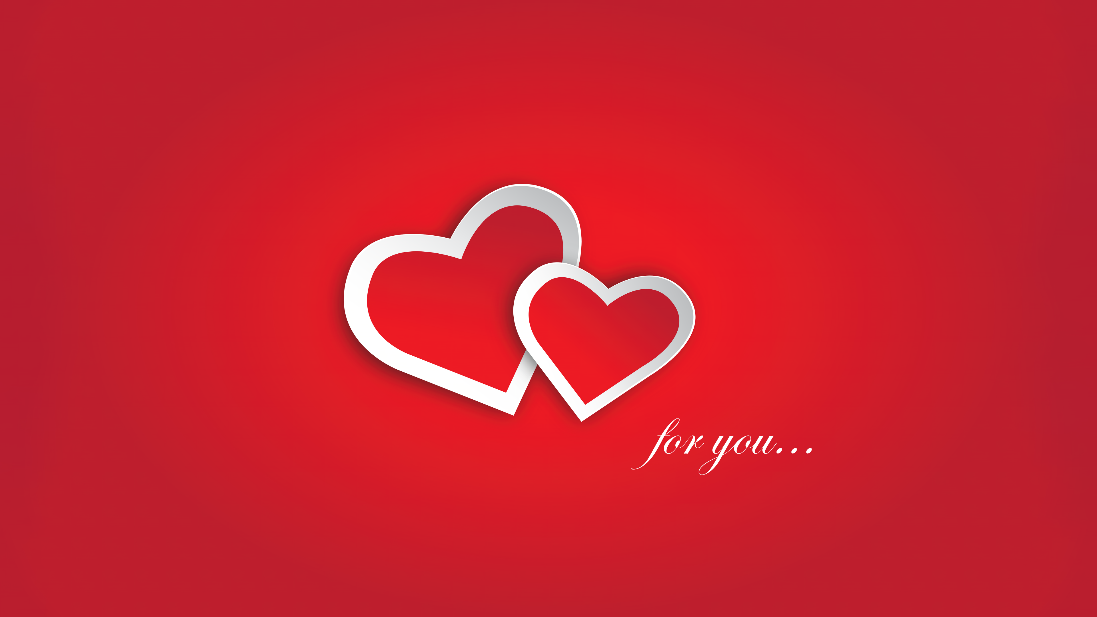 Minimalist red hearts on a solid red background for Valentine's Day.