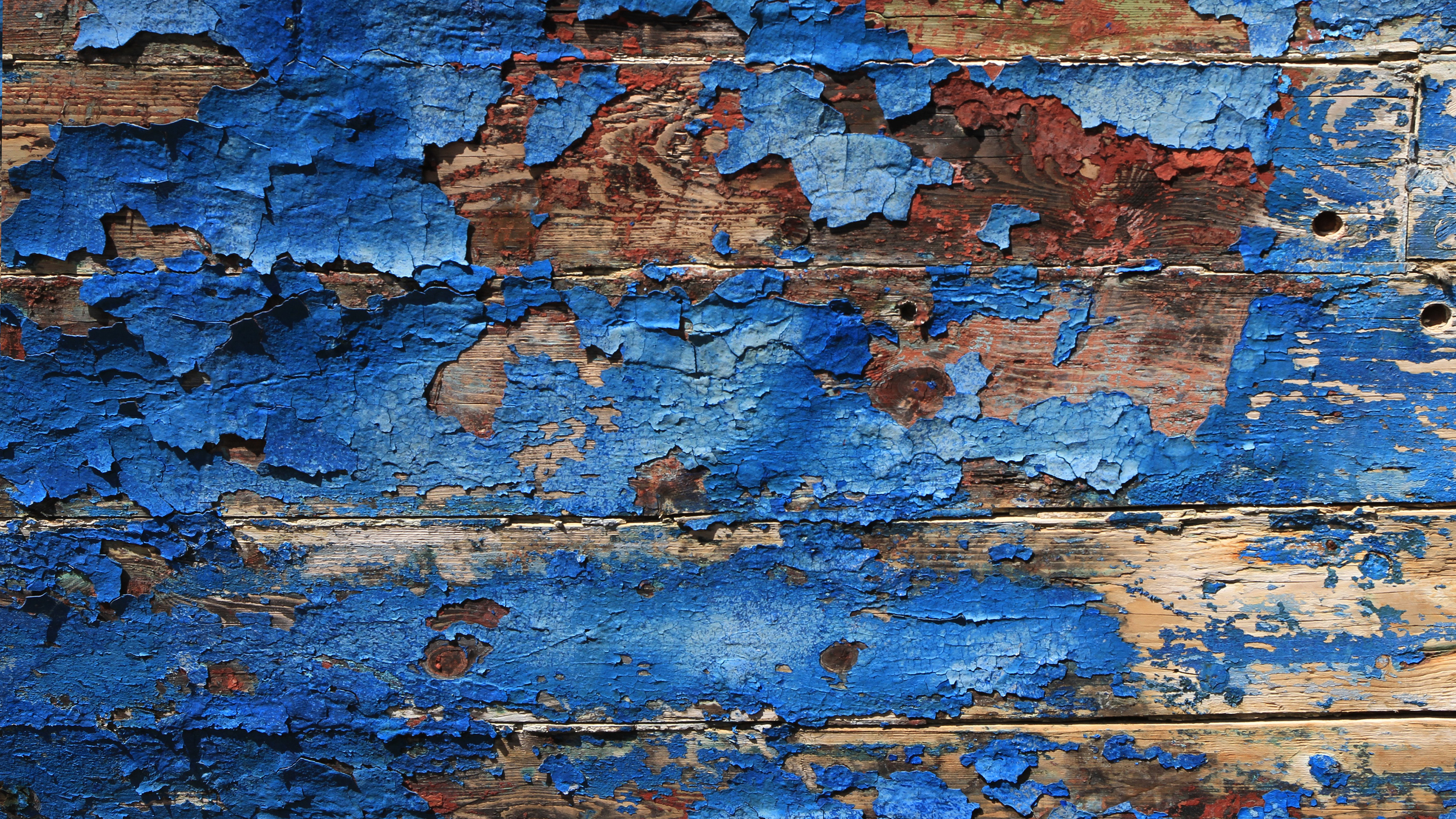An abstract texture featuring rustic wooden grain patterns paired with a deep blue background.