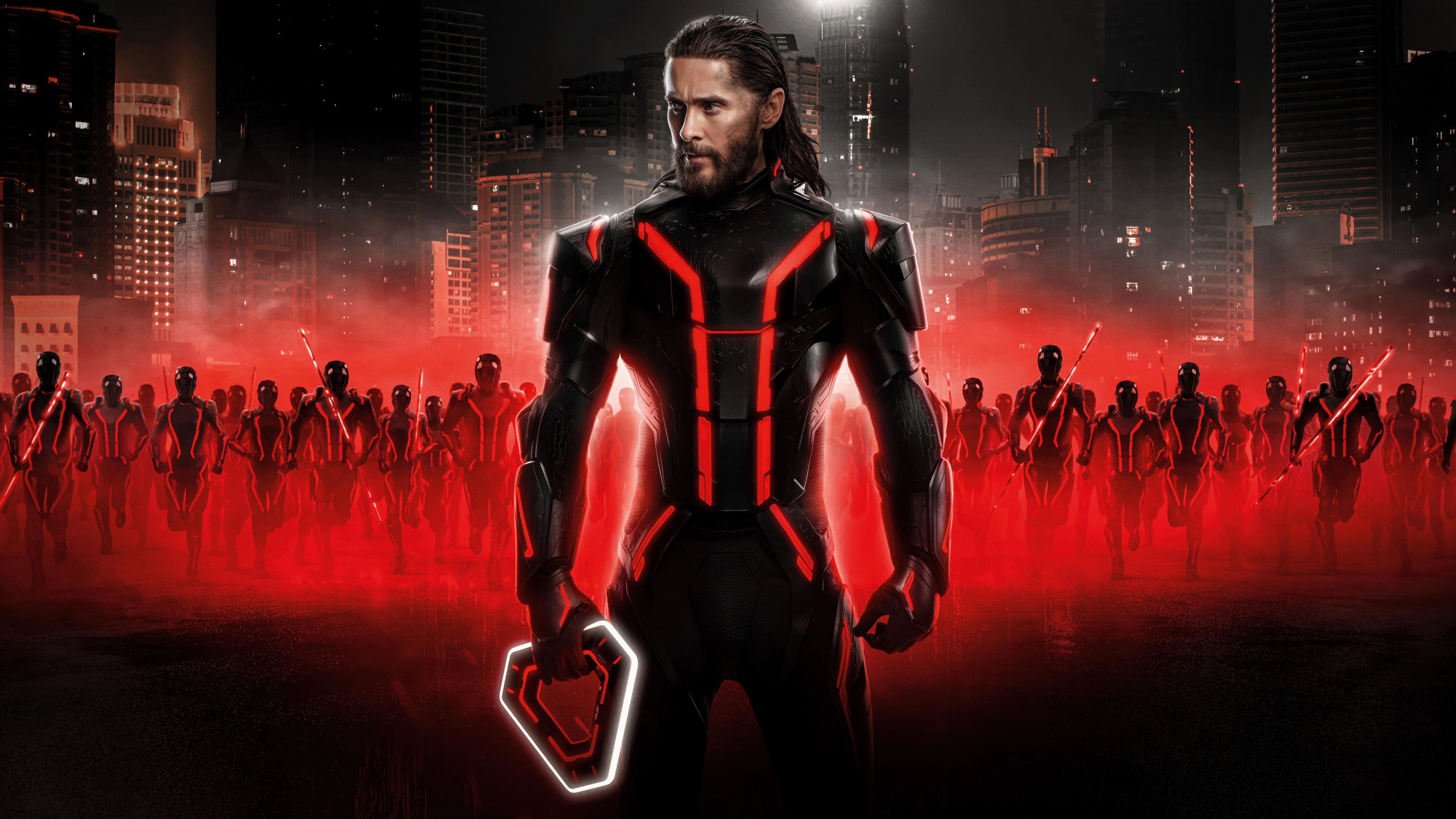 An ultra-wide cinematic view of the character Ares from Tron: Ares, surrounded by vibrant neon lights and digital circuitry in a futuristic setting.