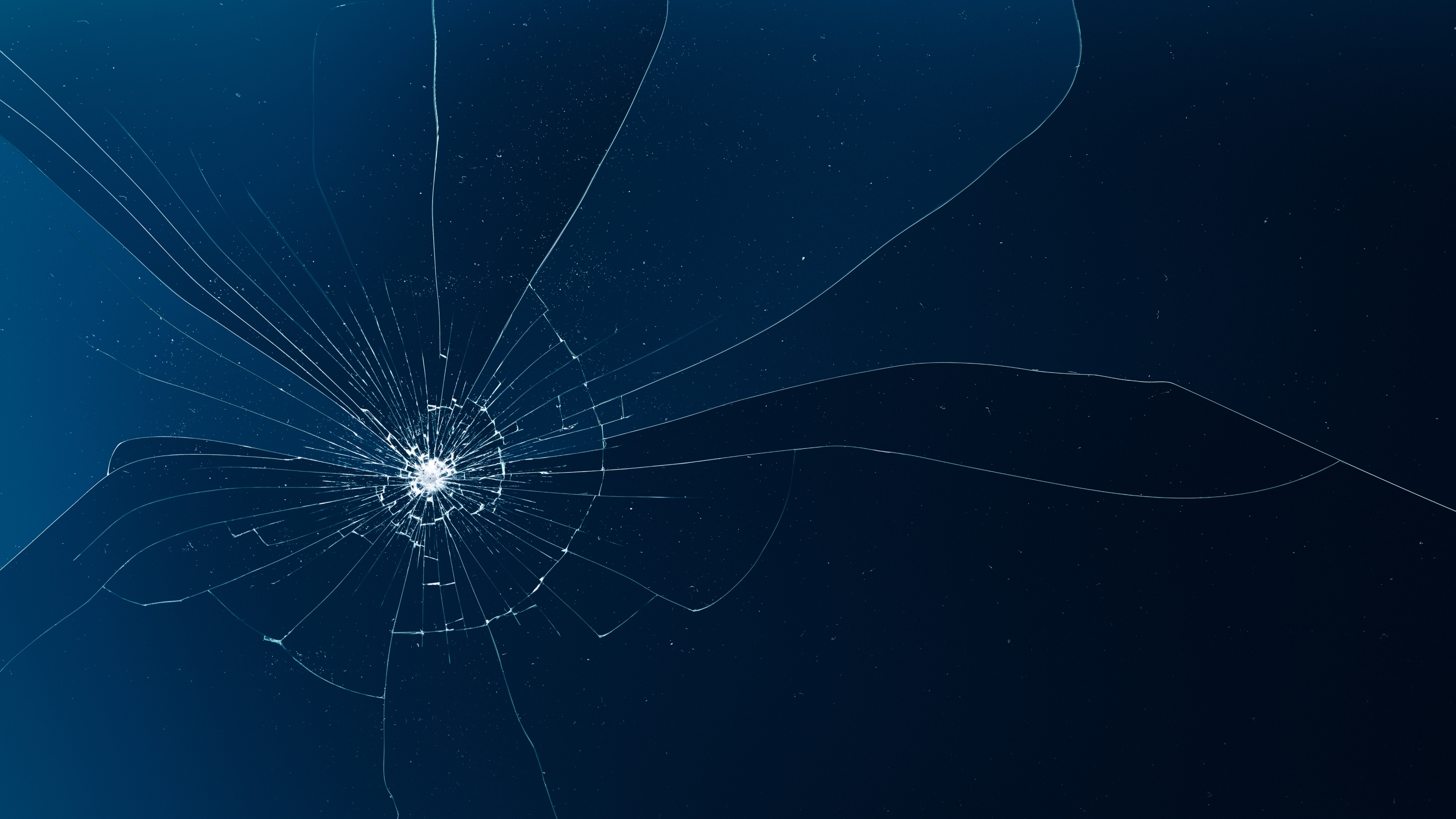Shattered glass shards and broken screen texture on a blue background.