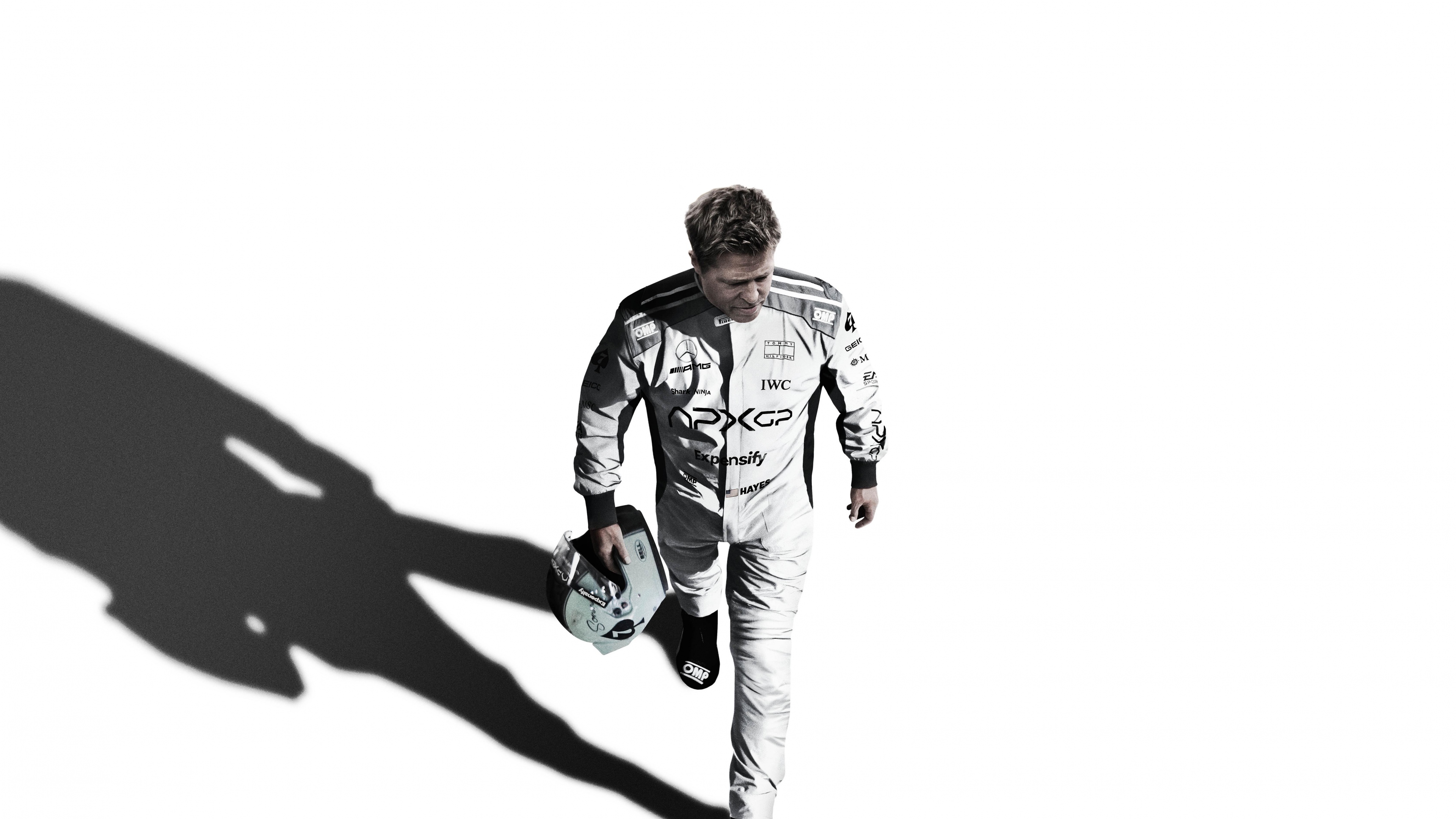 Cinematic movie poster of Brad Pitt for the 2025 film F1 featuring Mercedes AMG Petronas branding.