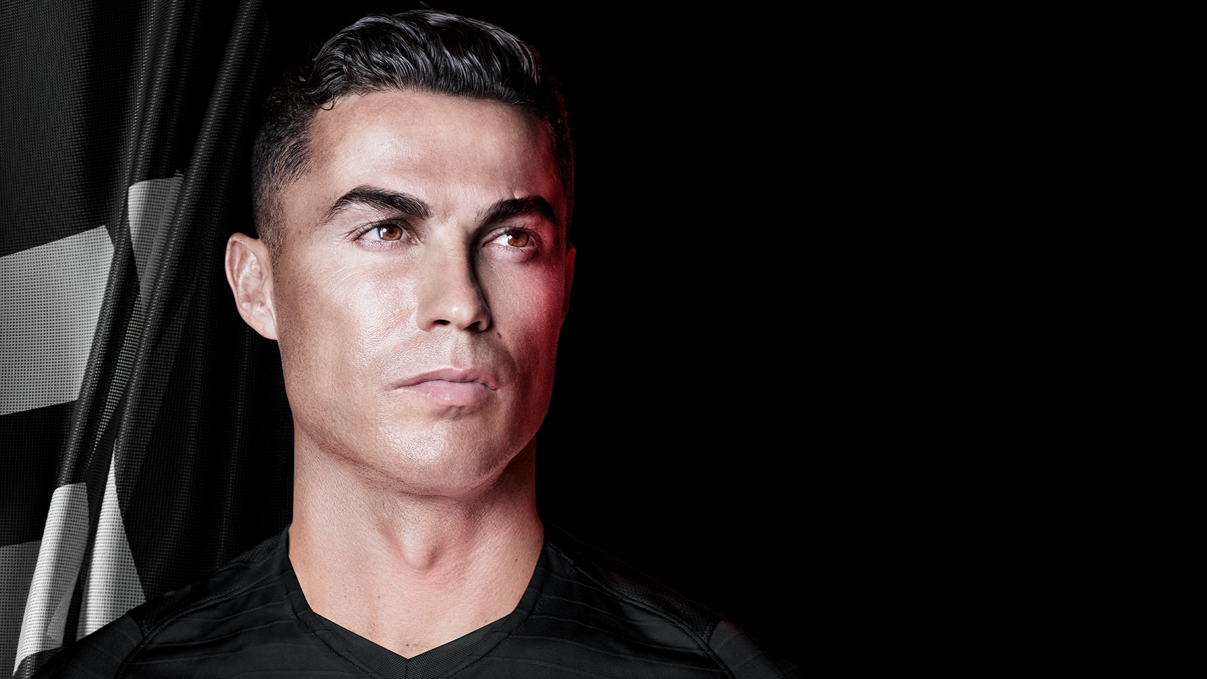 A cinematic 5K portrait of Cristiano Ronaldo with a dark theme and black background.