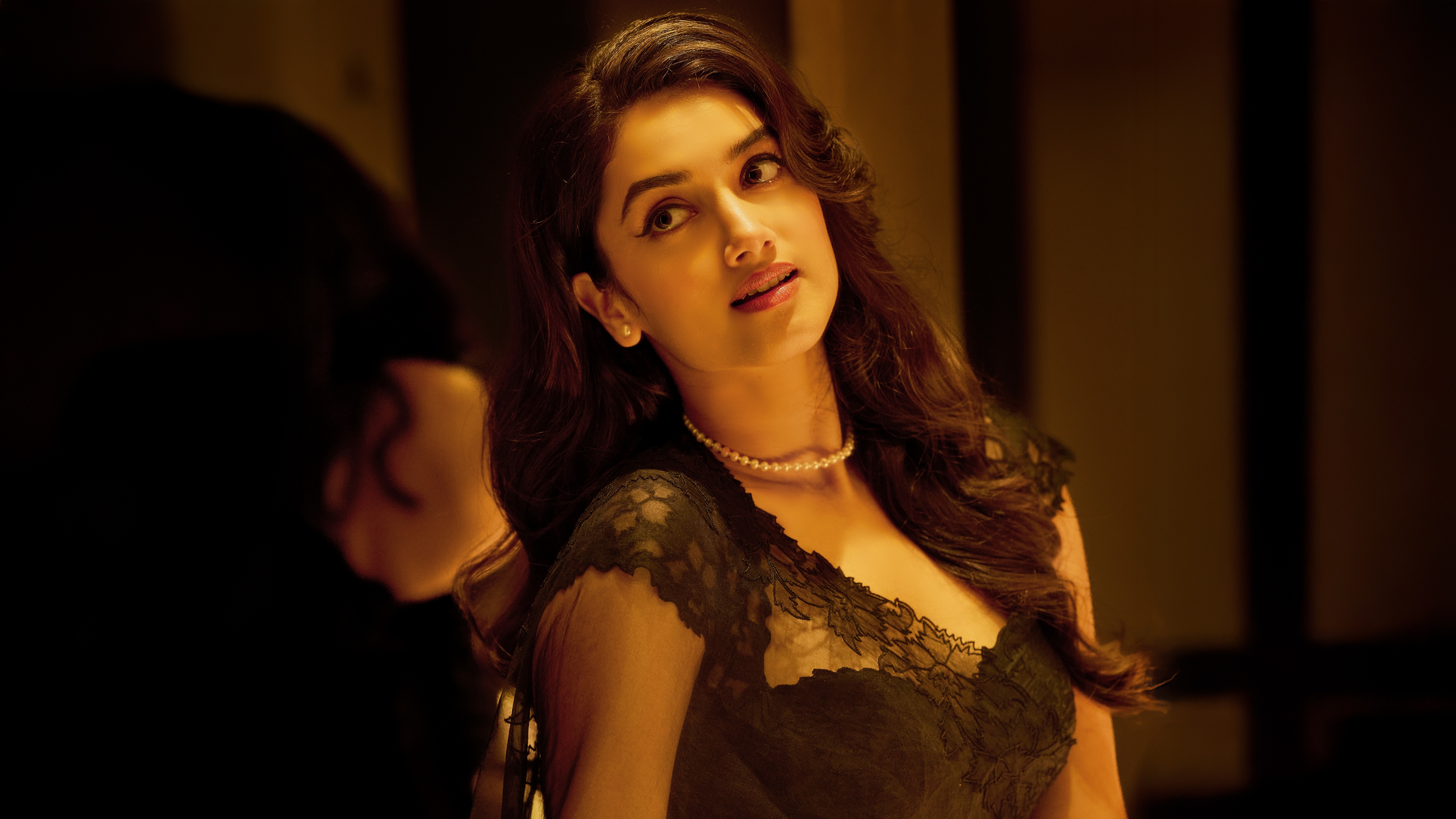 Indian actress Bhagyashri Borse posing gracefully in a stylish black saree