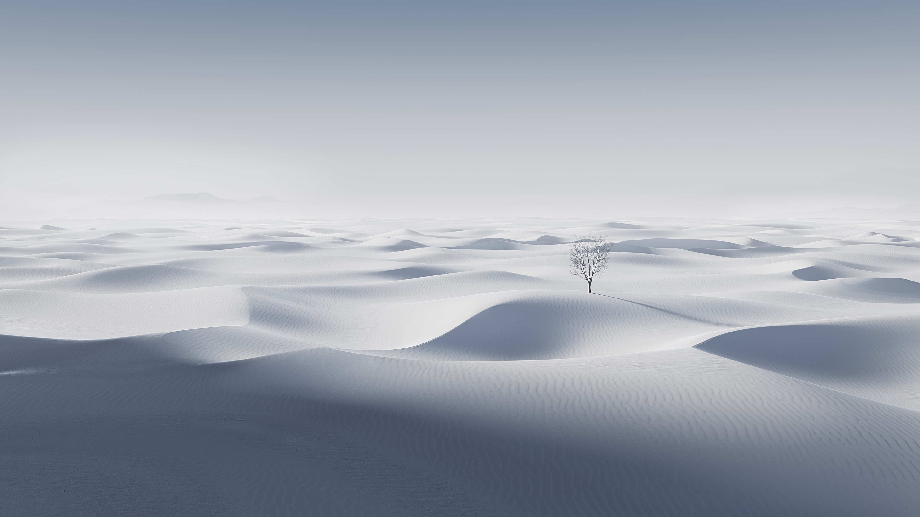A dreamlike, minimalist landscape of vast white sand dunes under a bright, ethereal light.