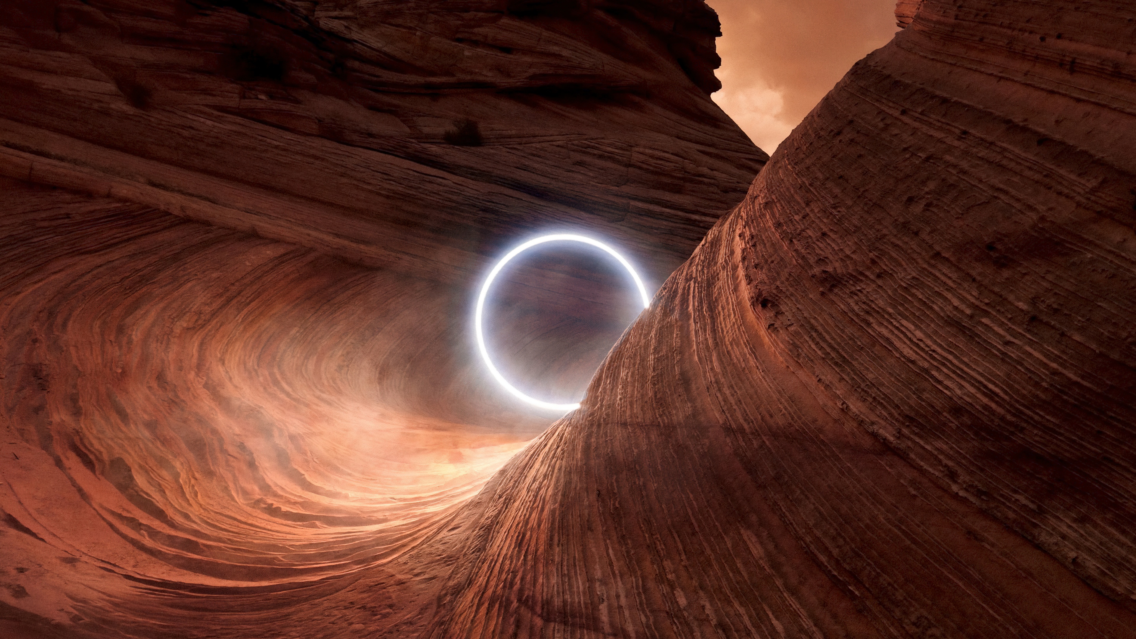 A scenic view of illuminated canyon rocks under a circular light at sunset.