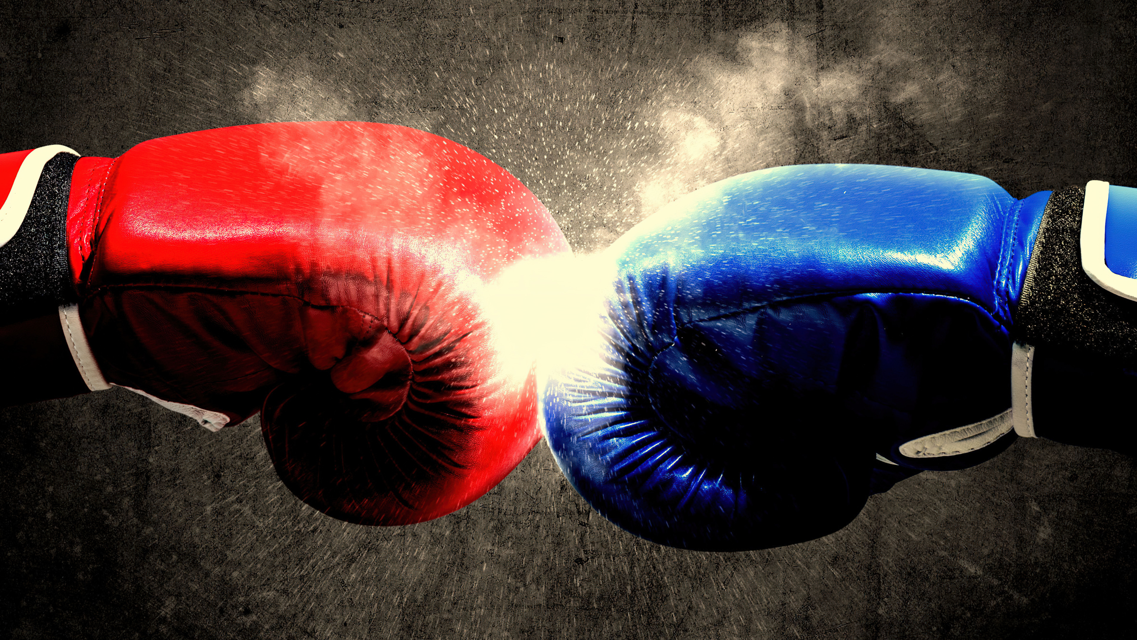 A close-up shot of a boxing glove delivering a powerful punch against a sepia-toned background.