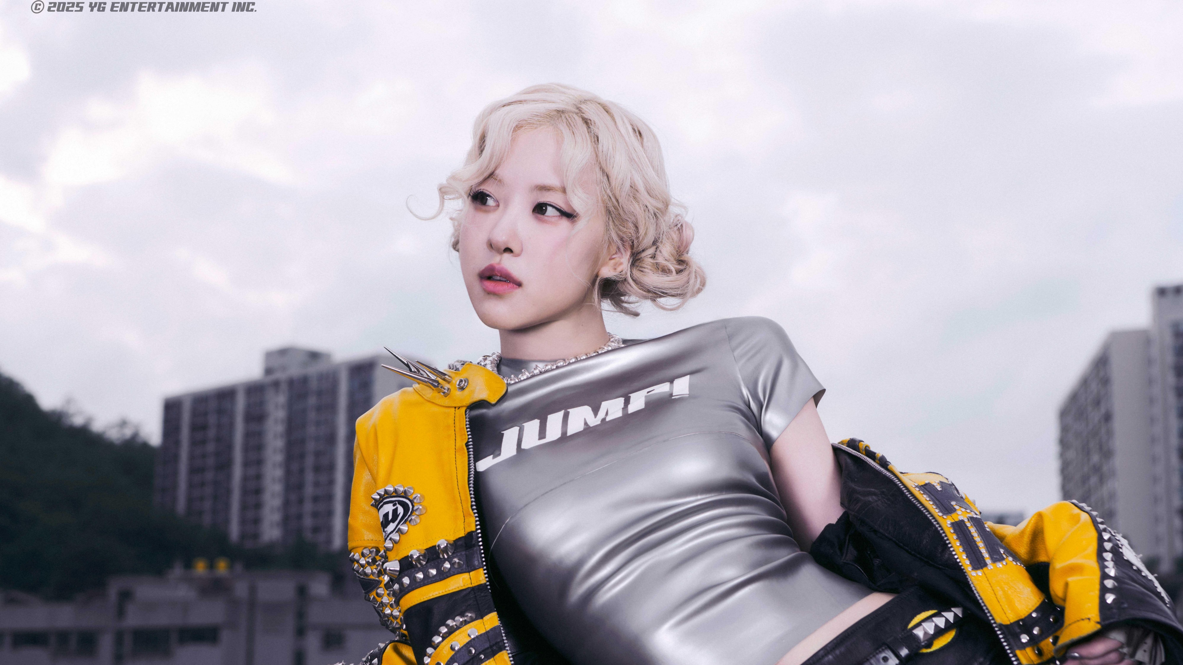 Portrait of a K-Pop singer wearing a reflective black latex outfit, featuring professional studio lighting and a high-fashion aesthetic.