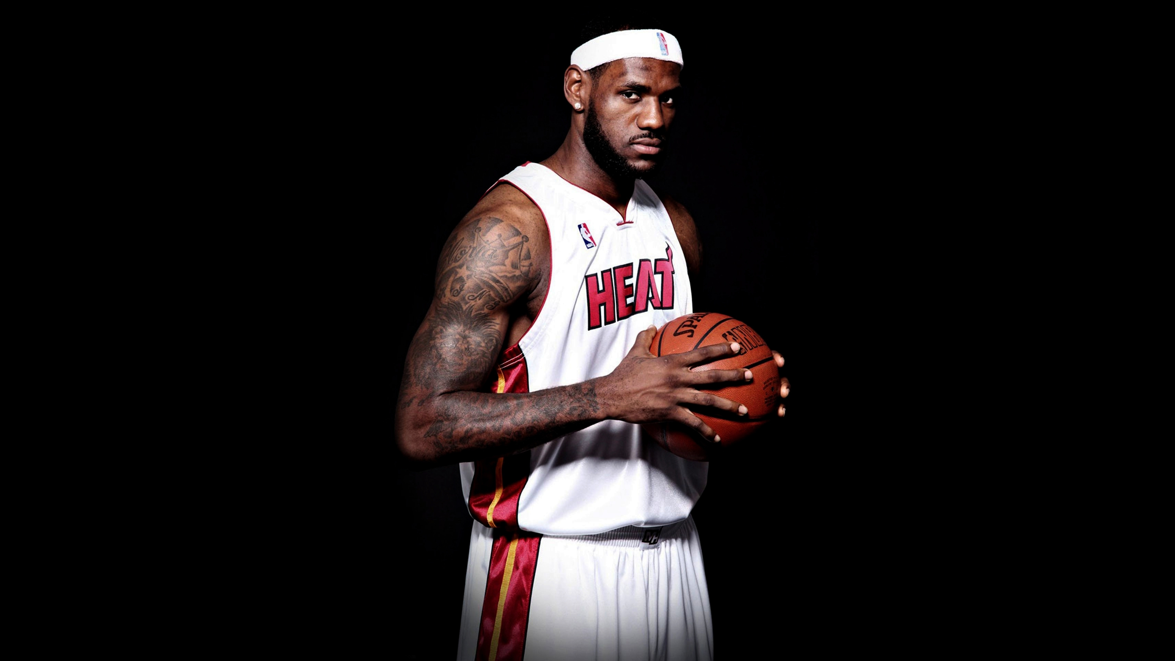 LeBron James in a Miami Heat basketball uniform against a solid black background
