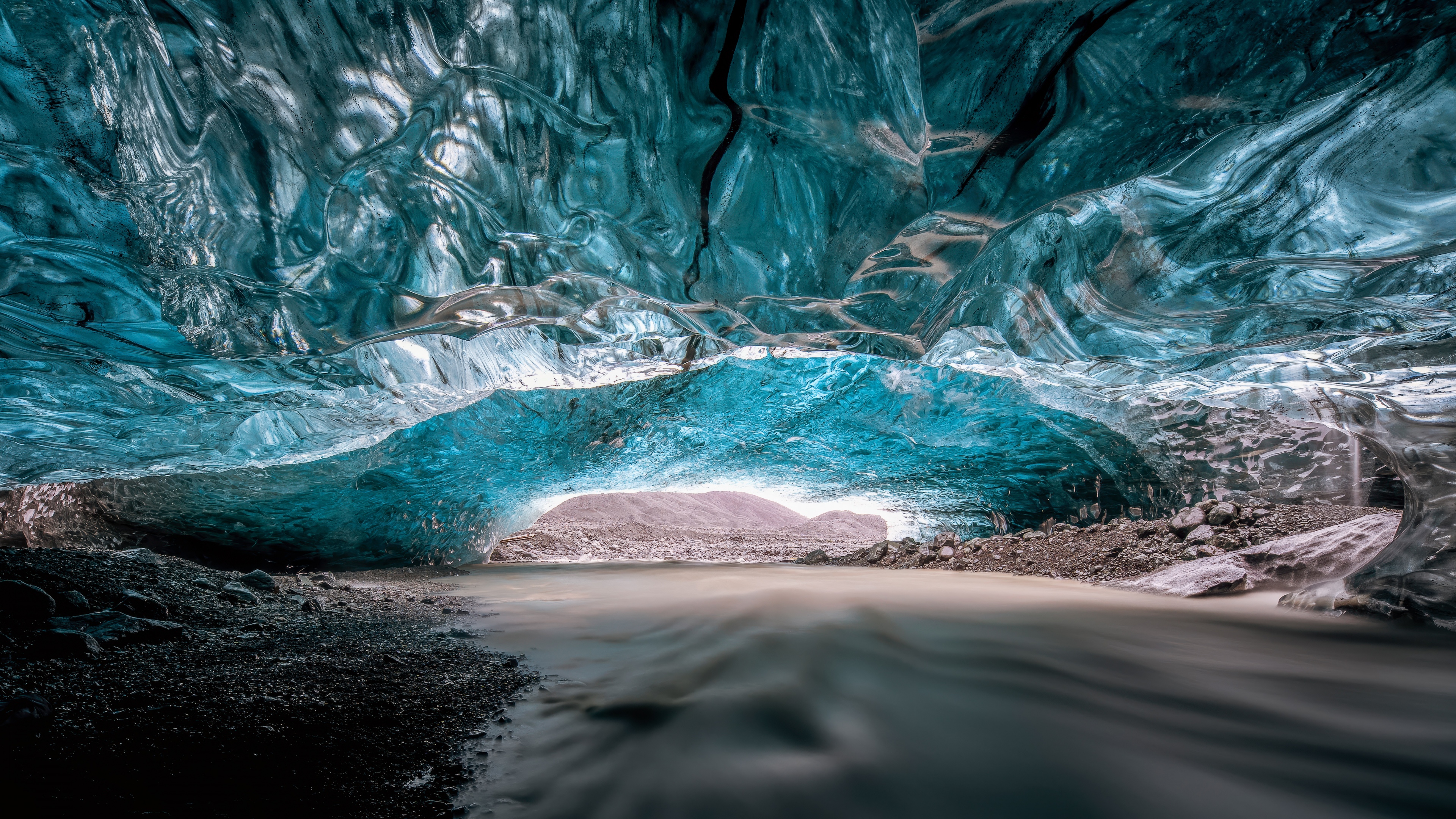An ultrawide 5K panoramic view of a massive glacier in Iceland featuring deep blue ice and snow.