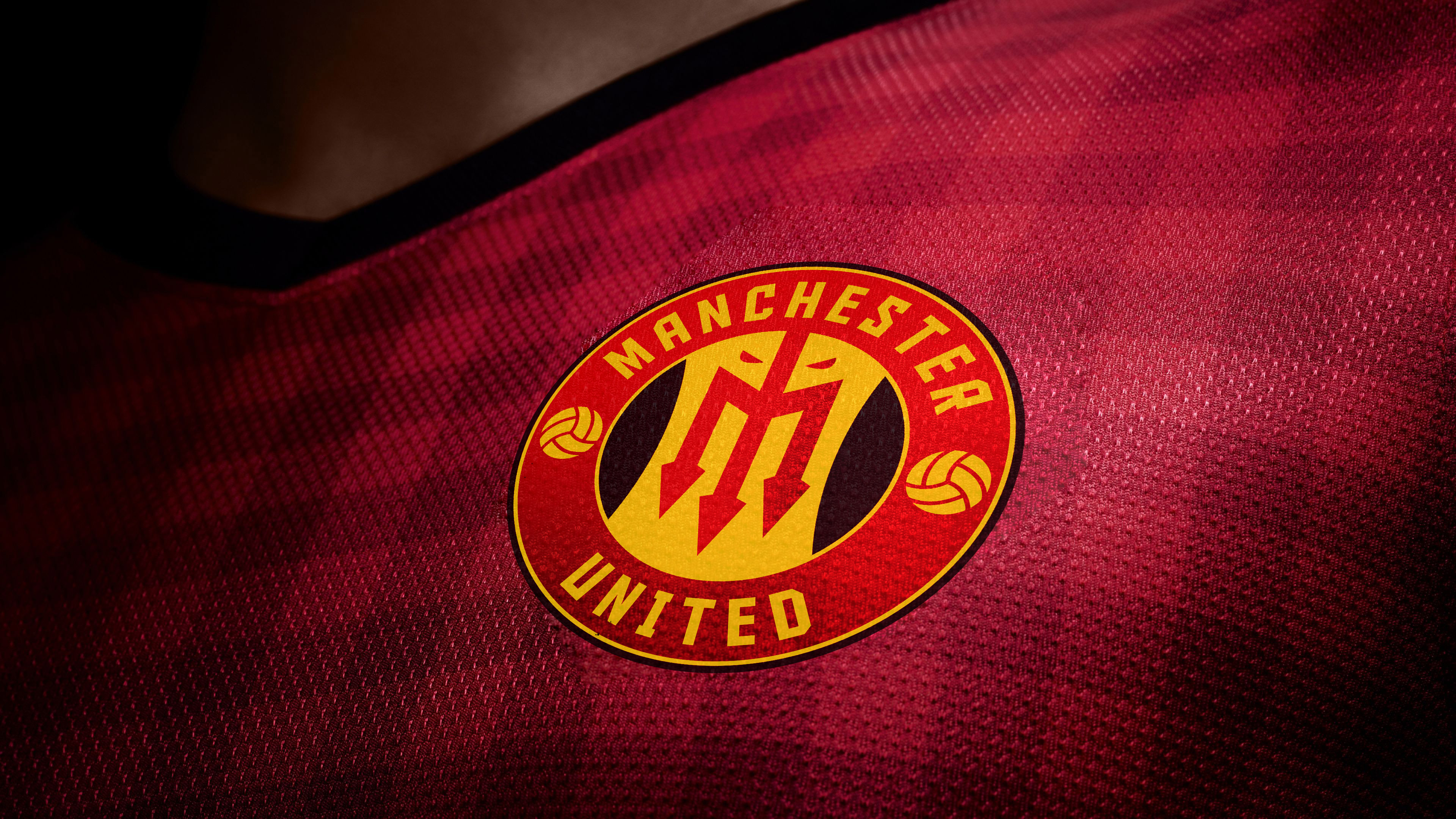 Close-up of the Manchester United red football jersey featuring the official club logo
