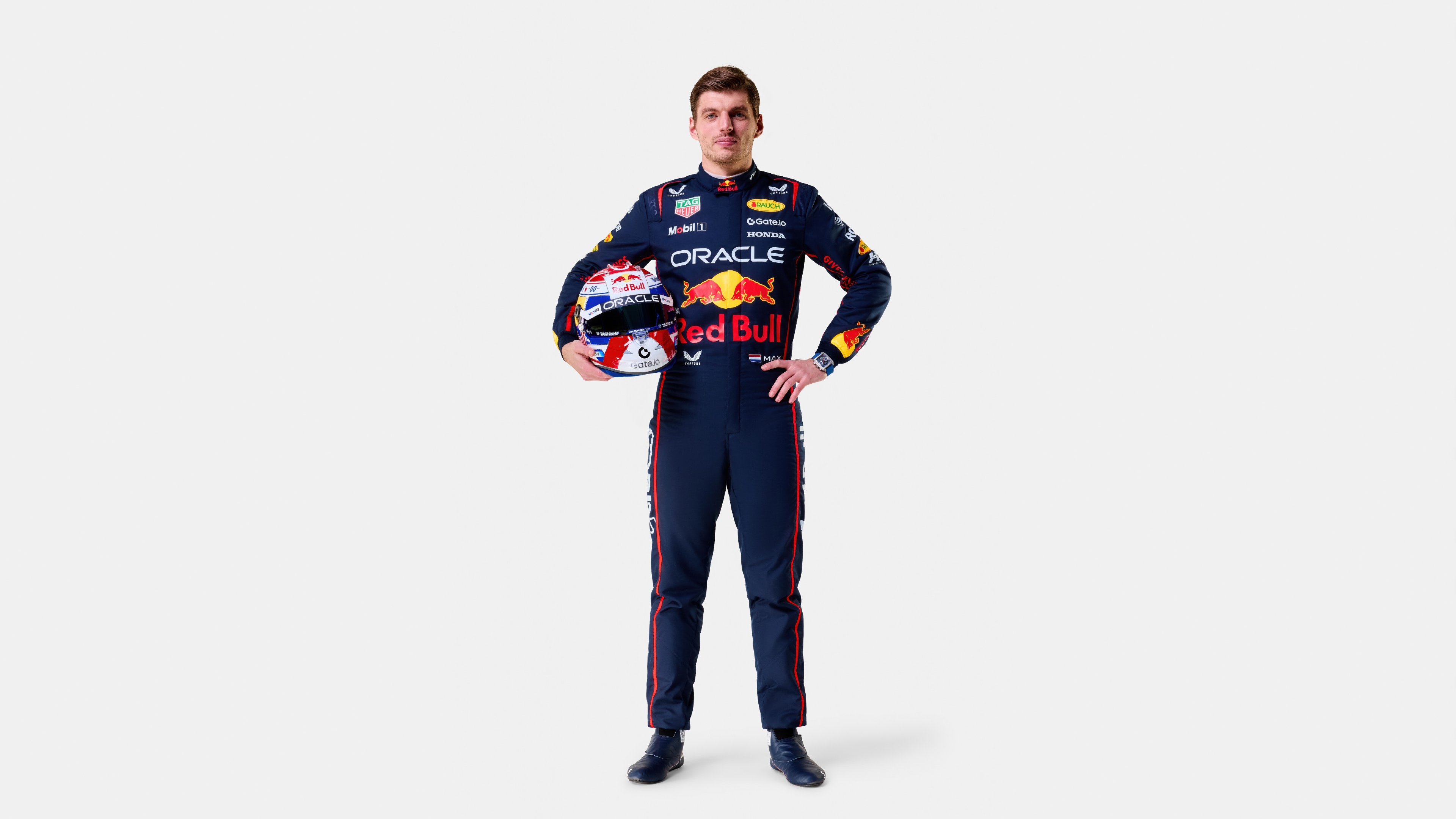 A professional studio portrait of Max Verstappen, the Red Bull Racing driver, on a white background.