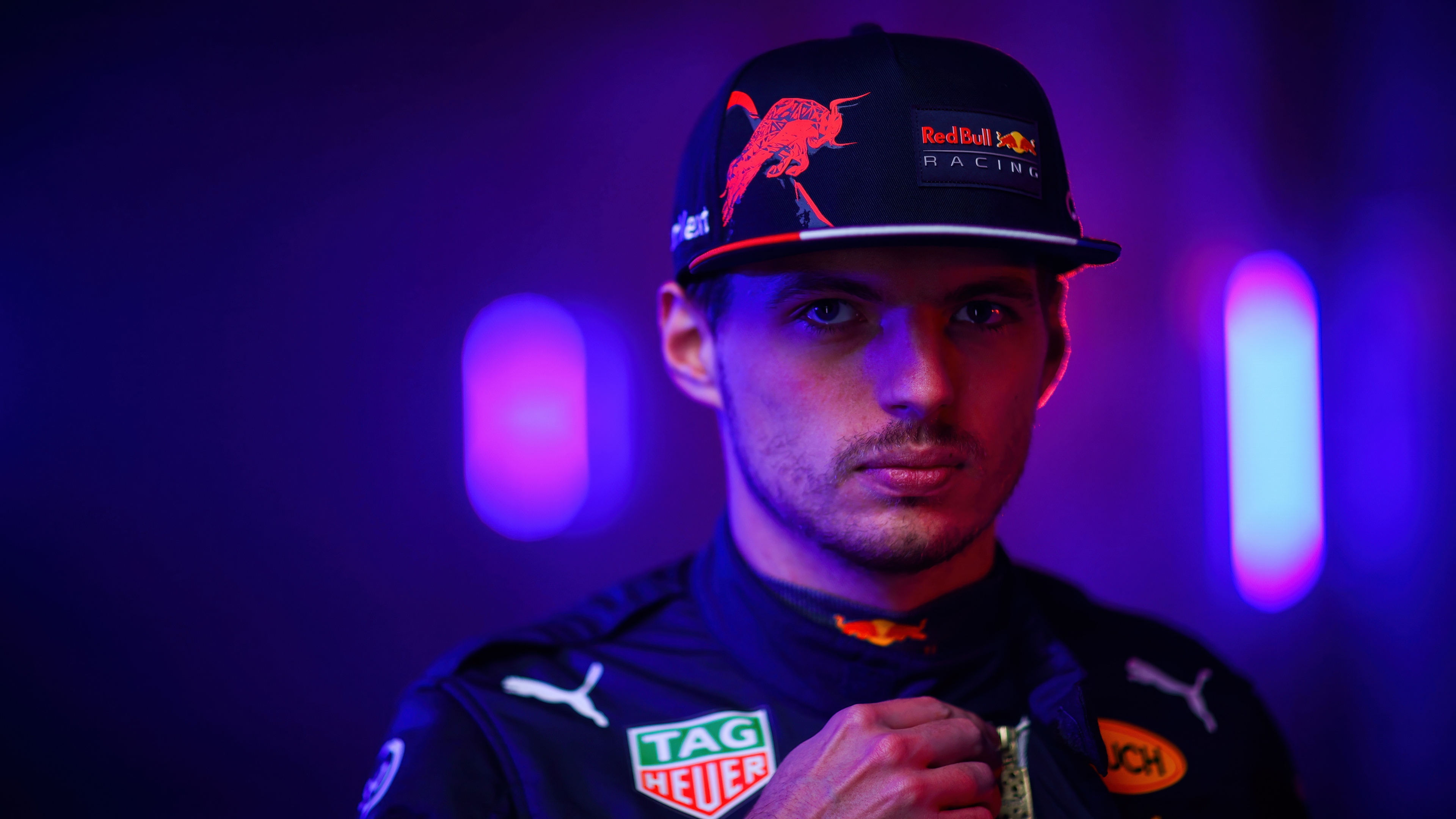 A neon-lit, cinematic portrait of Max Verstappen wearing Red Bull Racing gear.