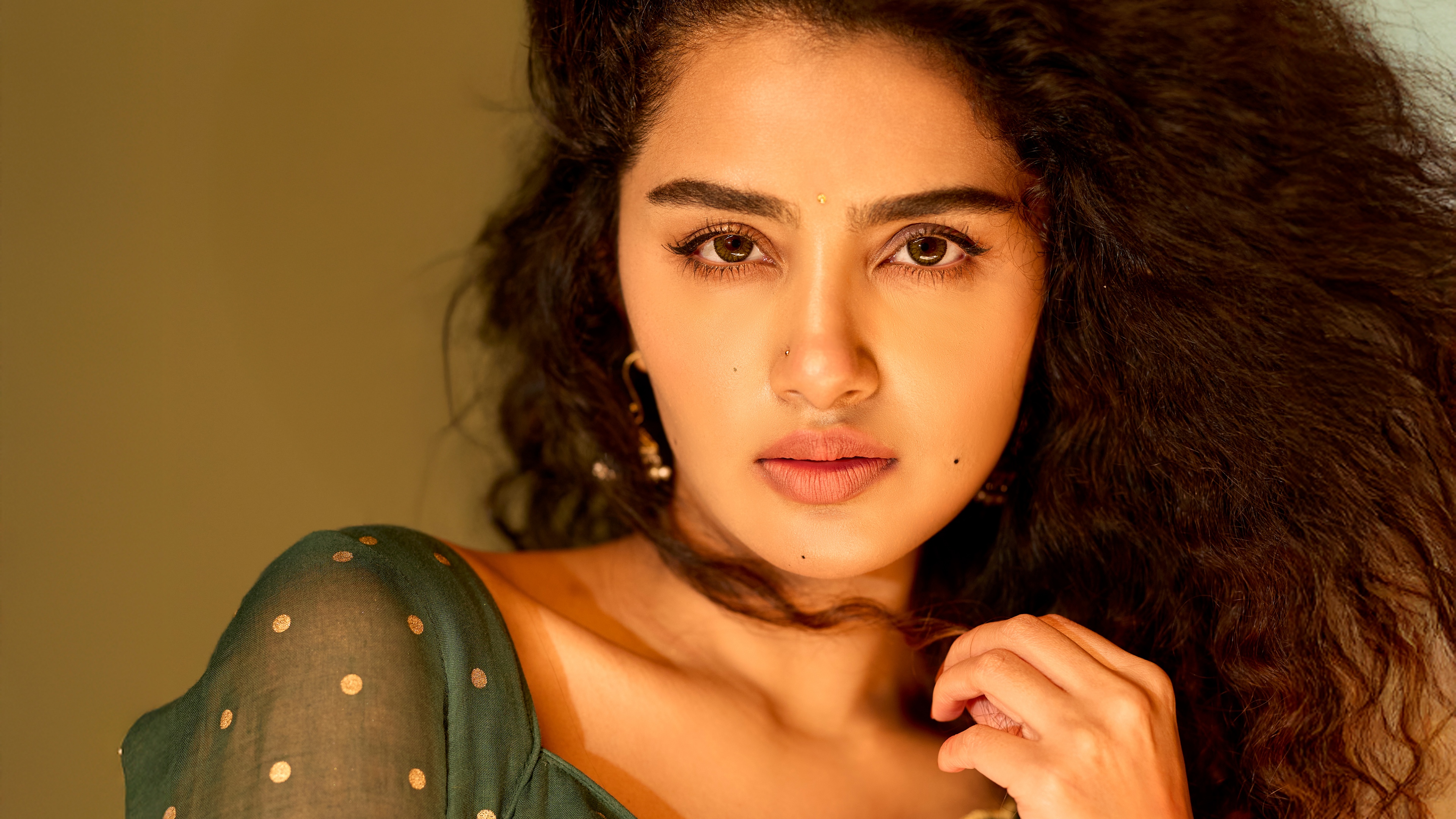 A high-detail portrait of Indian actress Anupama Parameswaran featuring her expressive eyes and elegant facial features.