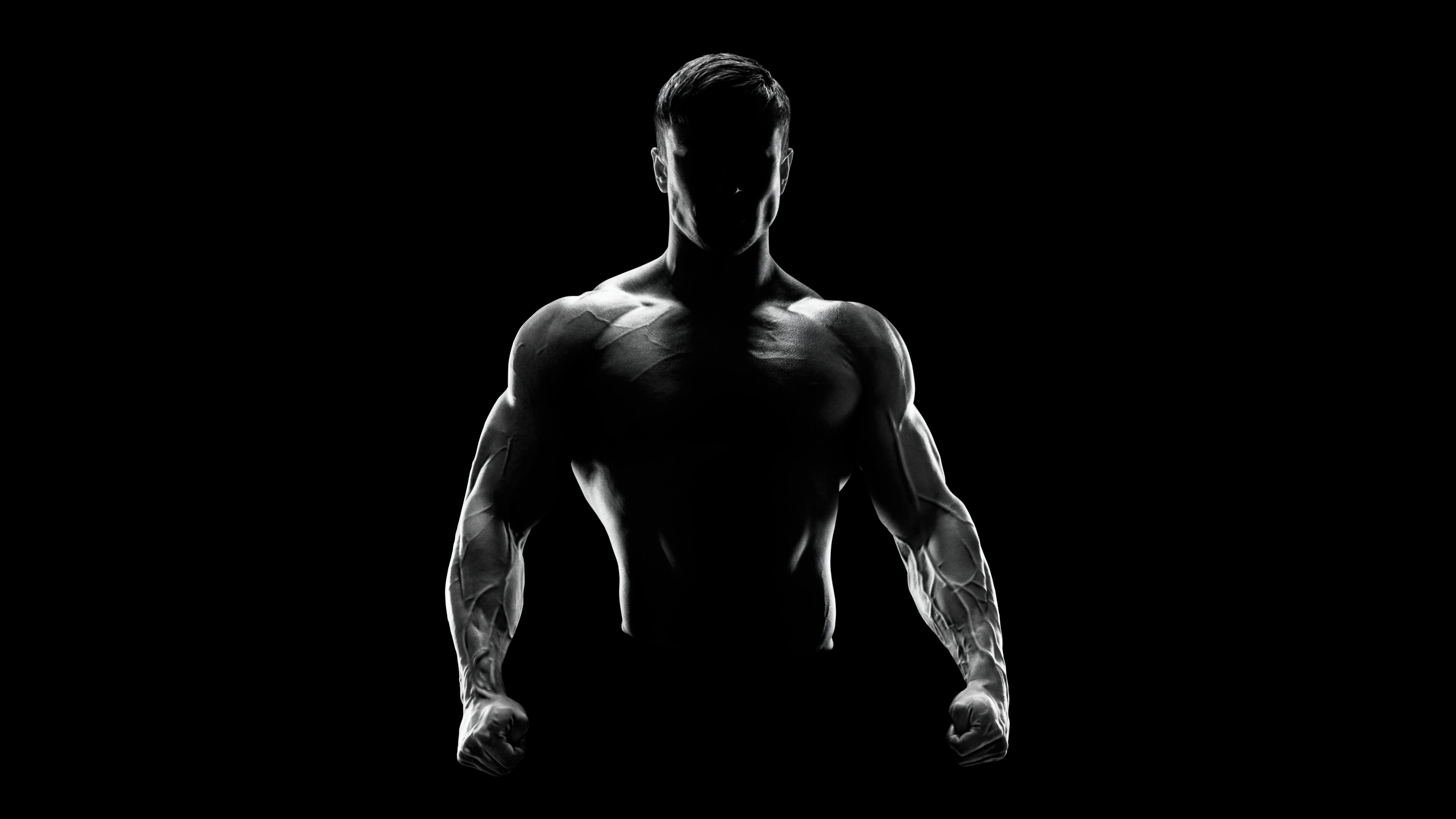 A powerful silhouette of a muscular bodybuilder against a deep black AMOLED background.