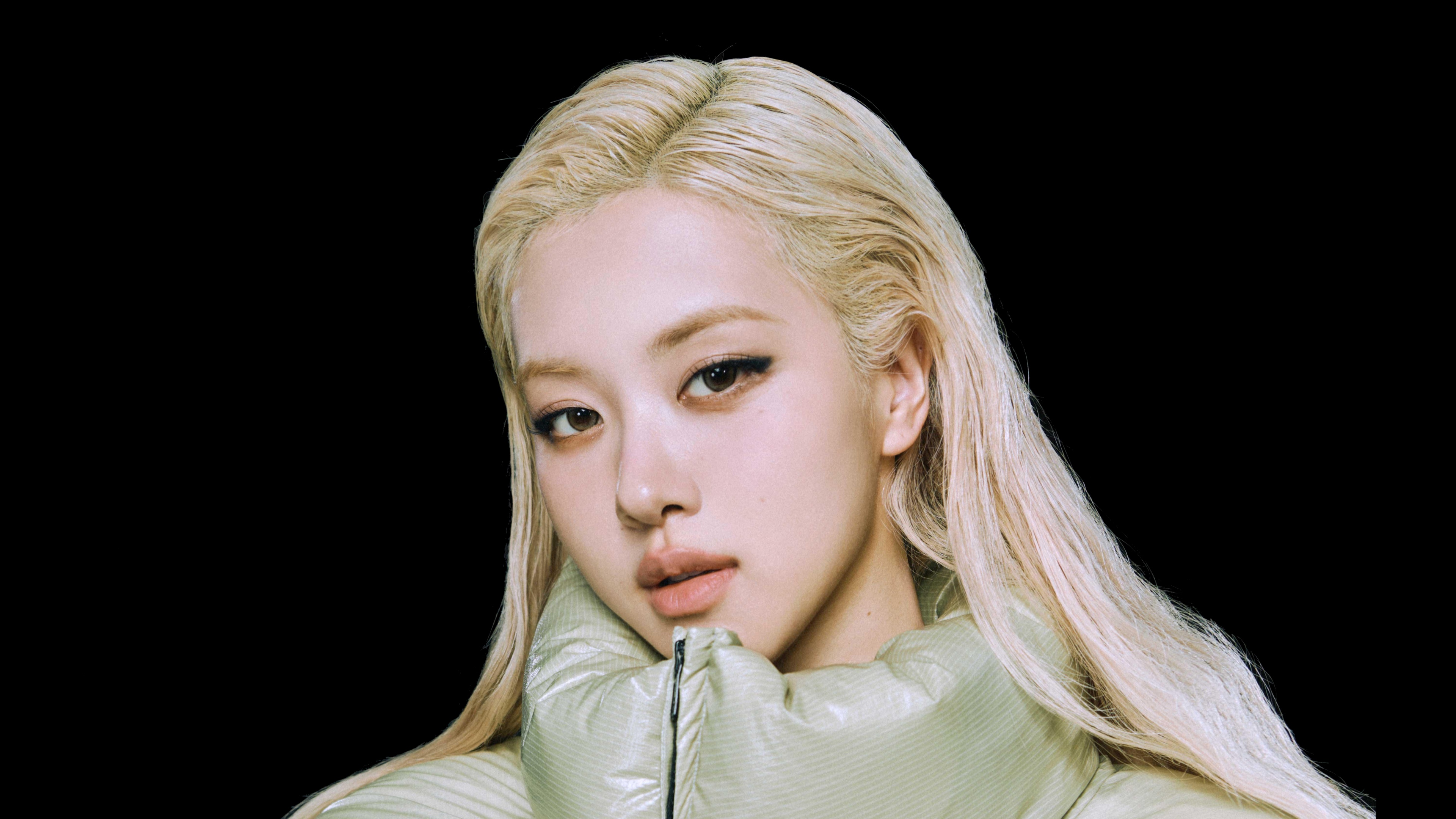 A high-definition, close-up portrait of Rosé from Blackpink against a solid black background.