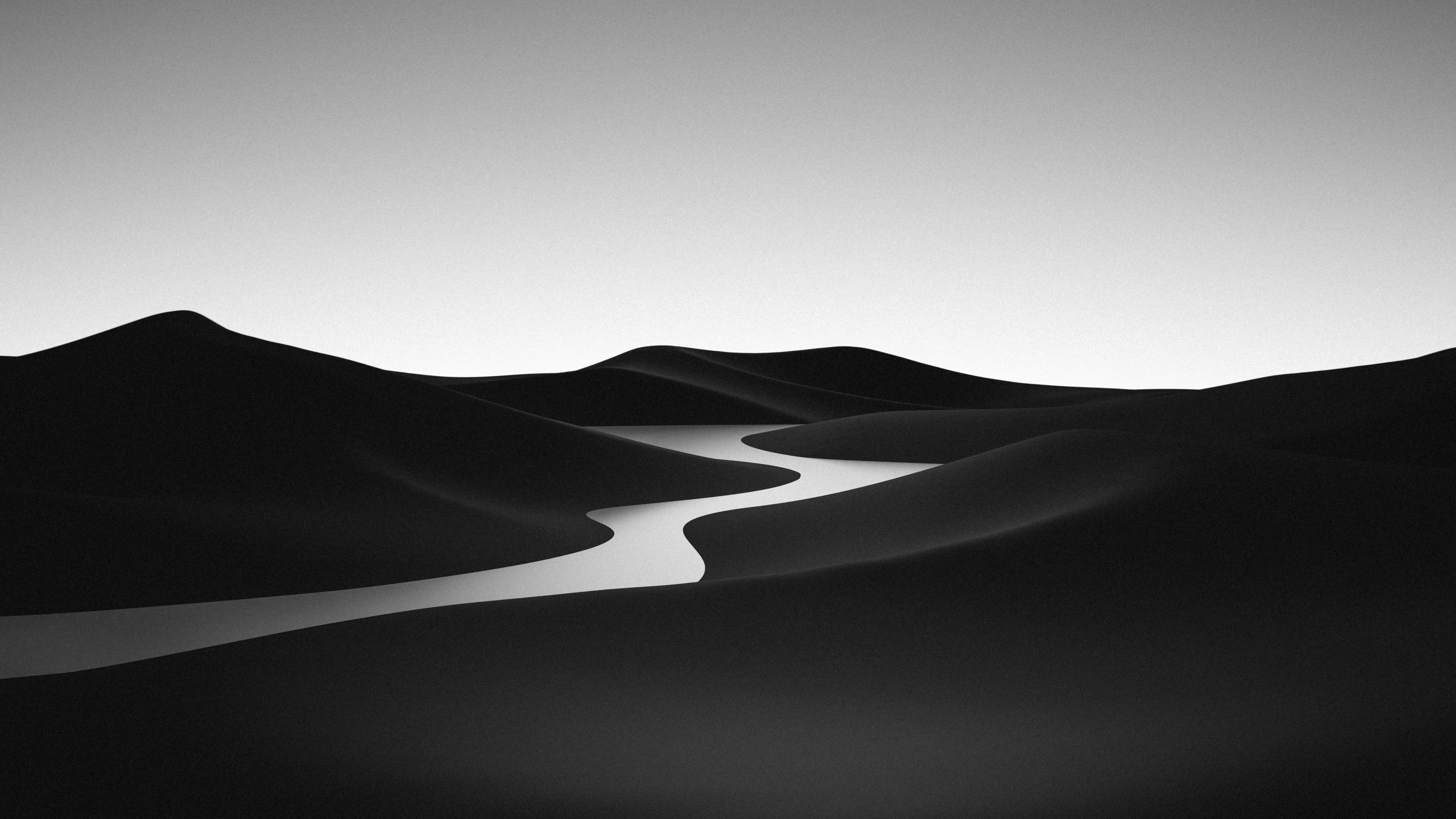 A black and white minimalist landscape of a river flowing through a vast desert.