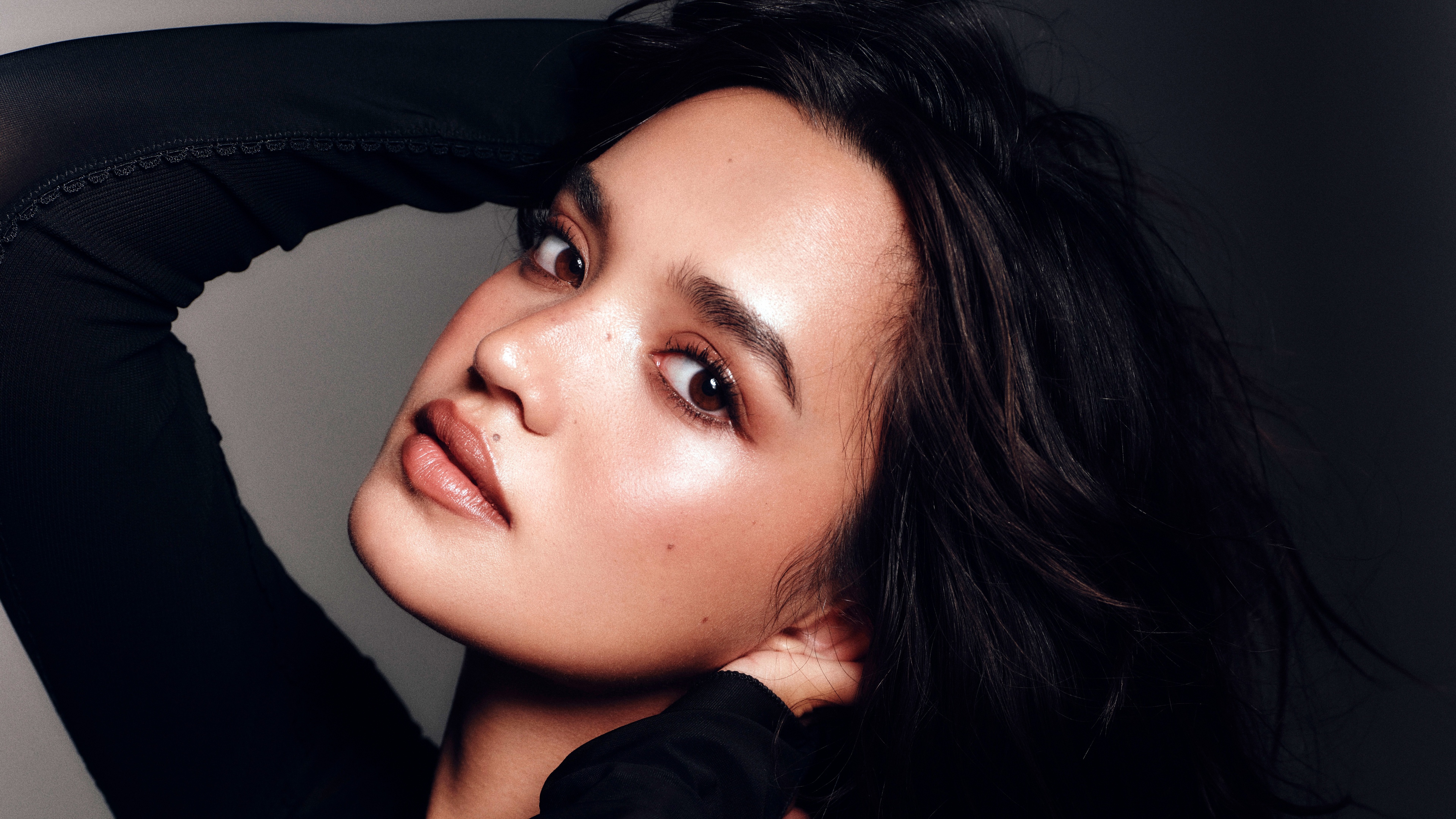 Close-up portrait of actress Sophia Hammons in a black dress with a dark background.