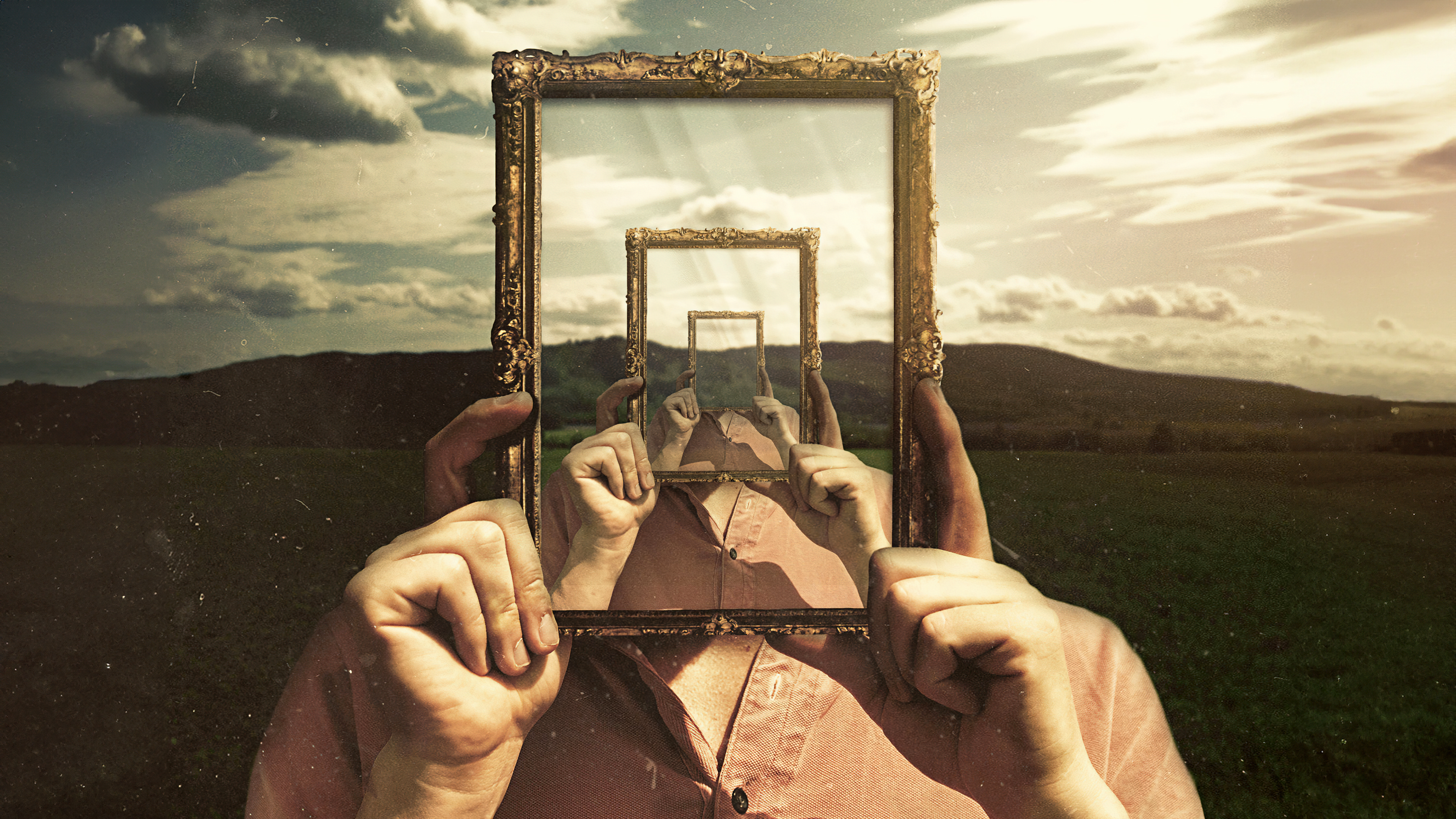 An ornate, decorative frame surrounding a surreal landscape of floating mountains and cosmic skies.
