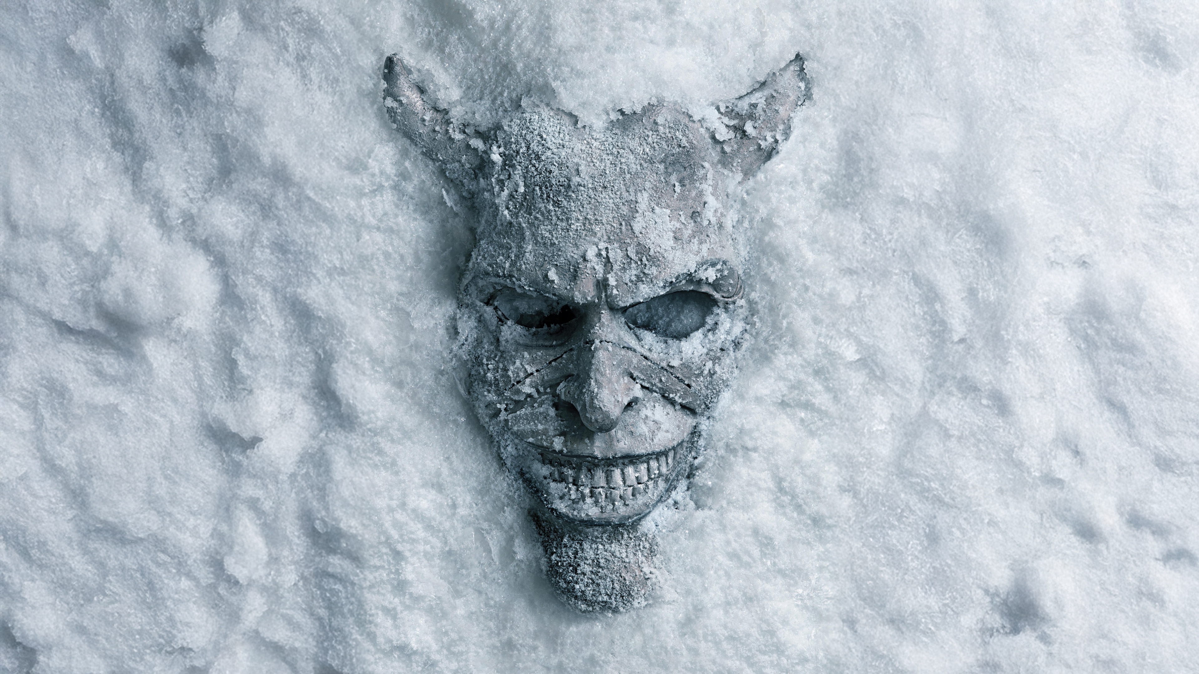 A terrifying demonic entity covered in snow and ice, emerging from a dark, frozen landscape.