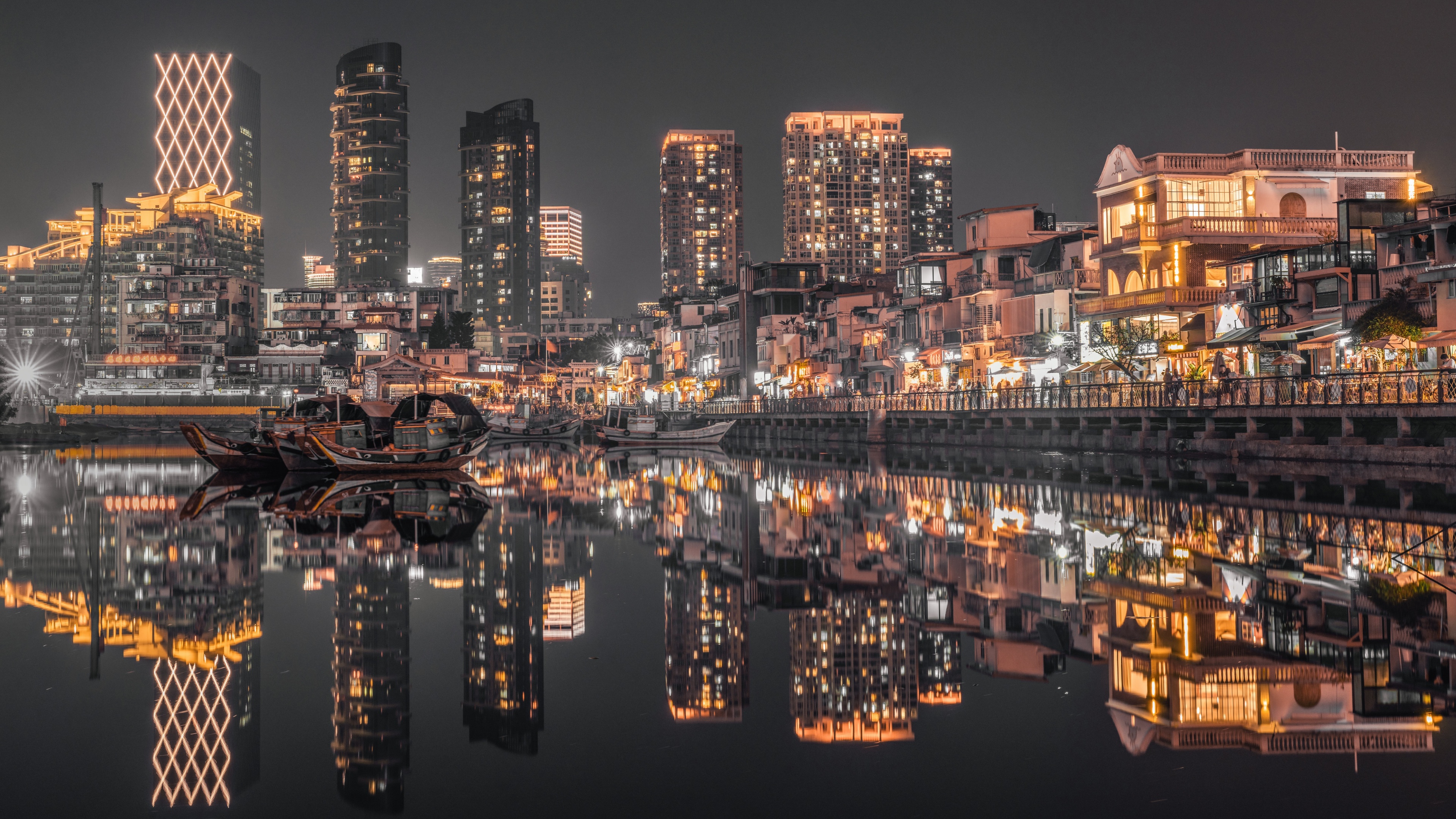 A stunning nighttime view of the Hong Kong city skyline featuring brightly lit skyscrapers and urban illumination.