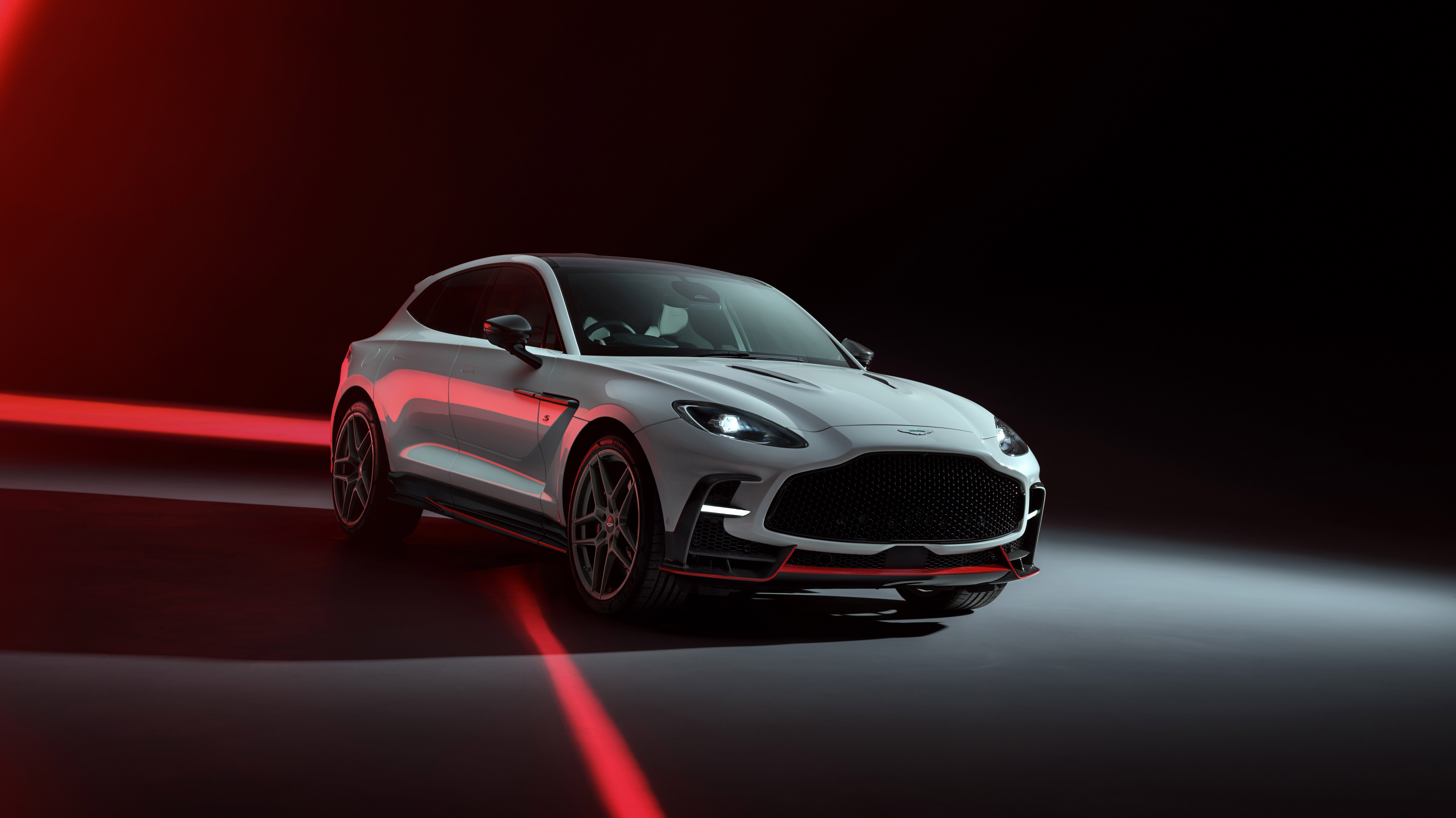 A high-detail, cinematic shot of the 2025 Aston Martin DBX S luxury performance SUV.