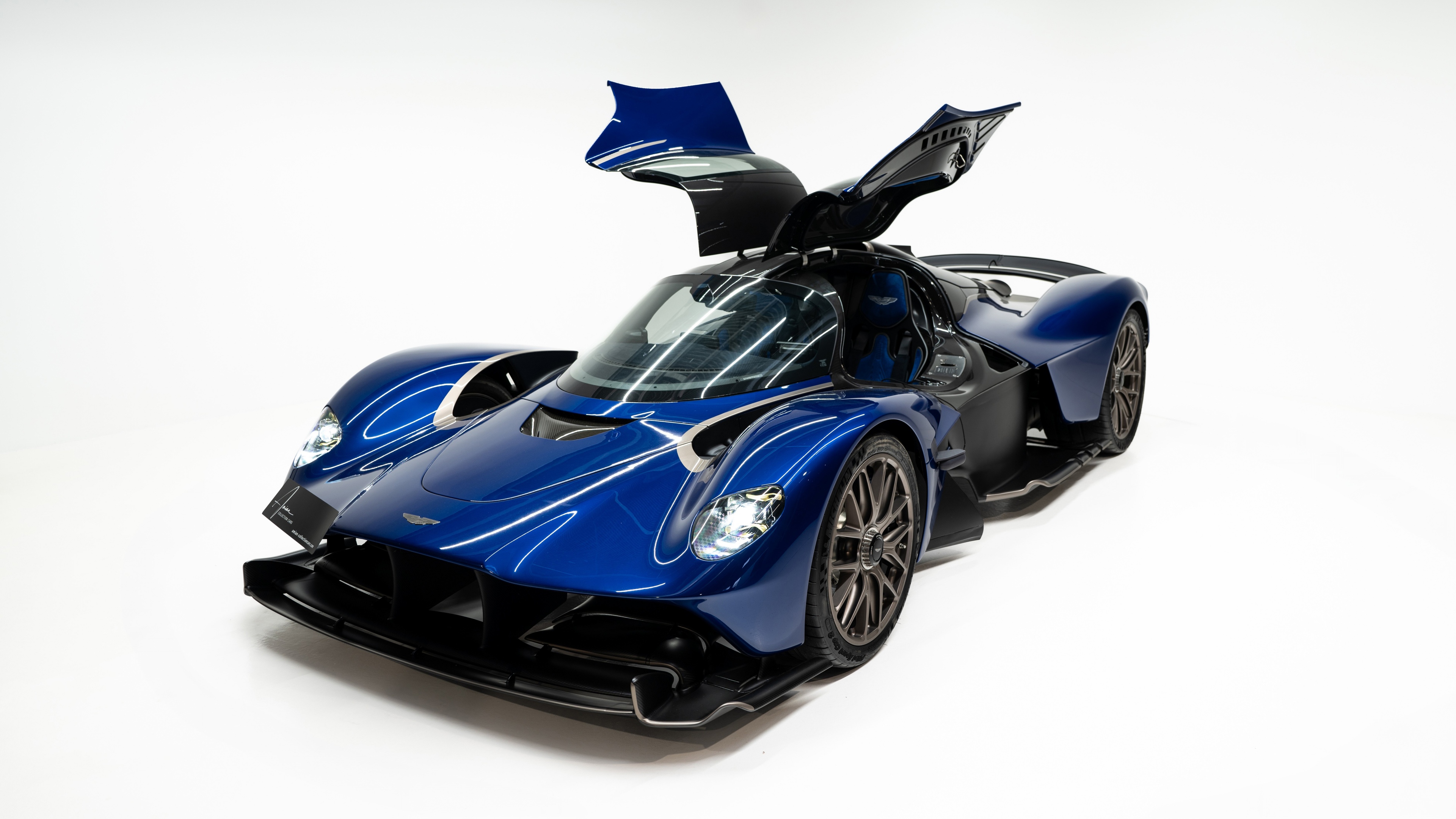 High-resolution studio shot of an Aston Martin Valkyrie hybrid sports car on a white background.