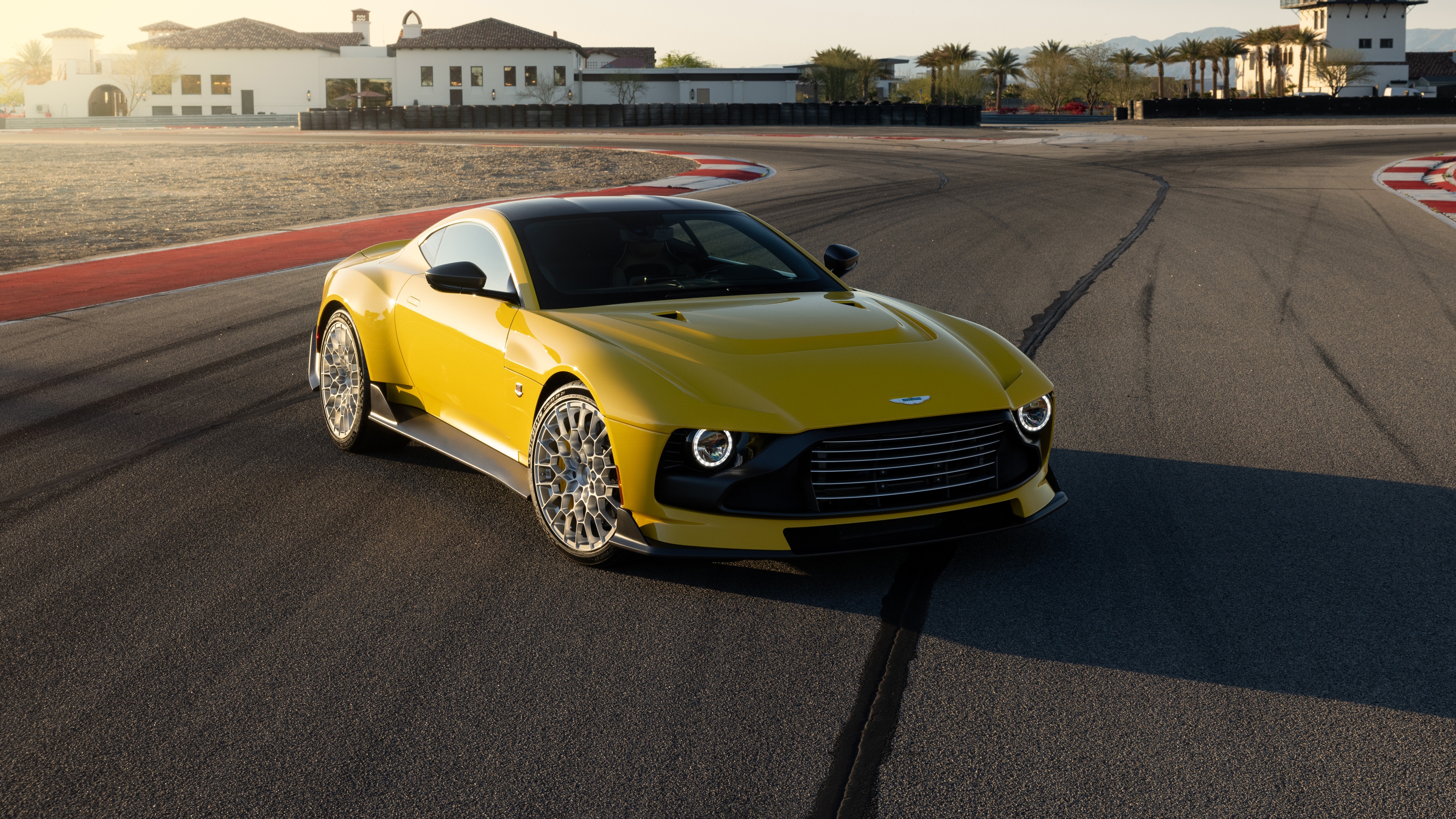 An Aston Martin Valour supercar driving at high speed on a professional race track.