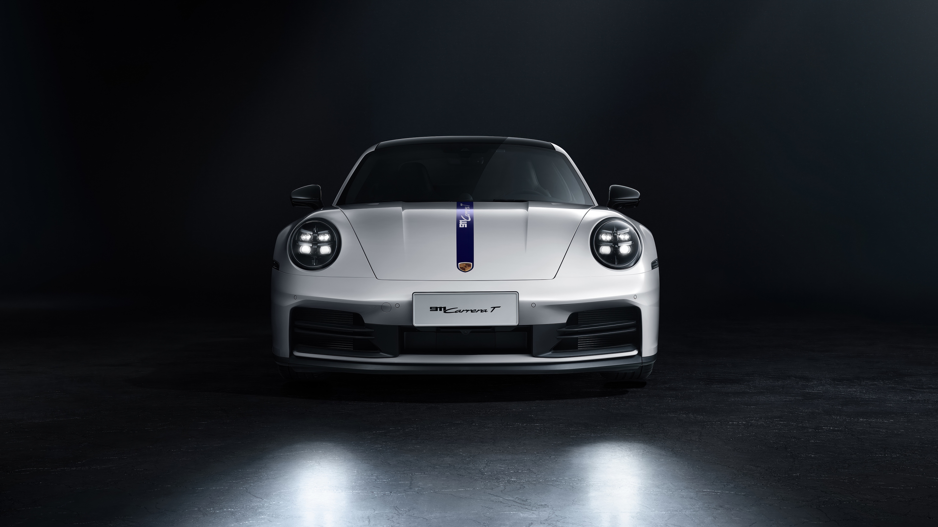 White Porsche 911 Carrera T with racing stripes on a dark background